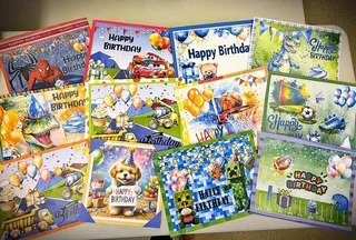 Collection of colorful birthday greeting cards with various themed designs including animals, balloons, and festive scenes.