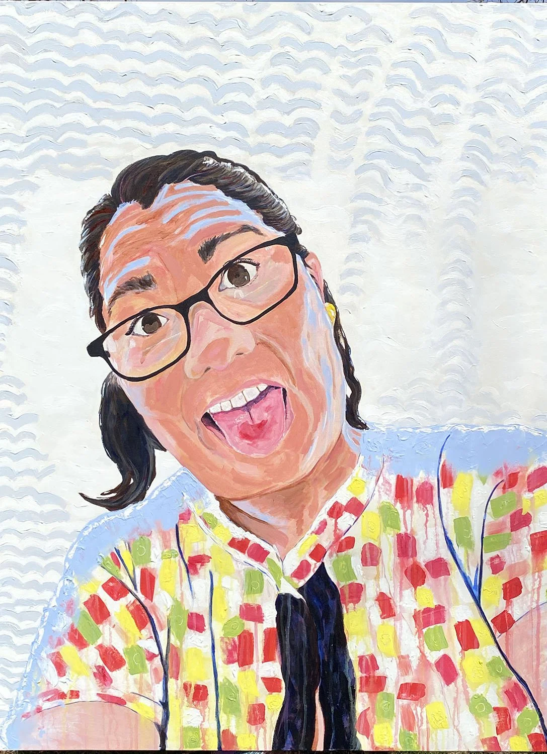 Colorful portrait of a woman with glasses making a funny face, sticking out her tongue, wearing a patterned shirt with red, yellow, and green squares, against a white textured background.