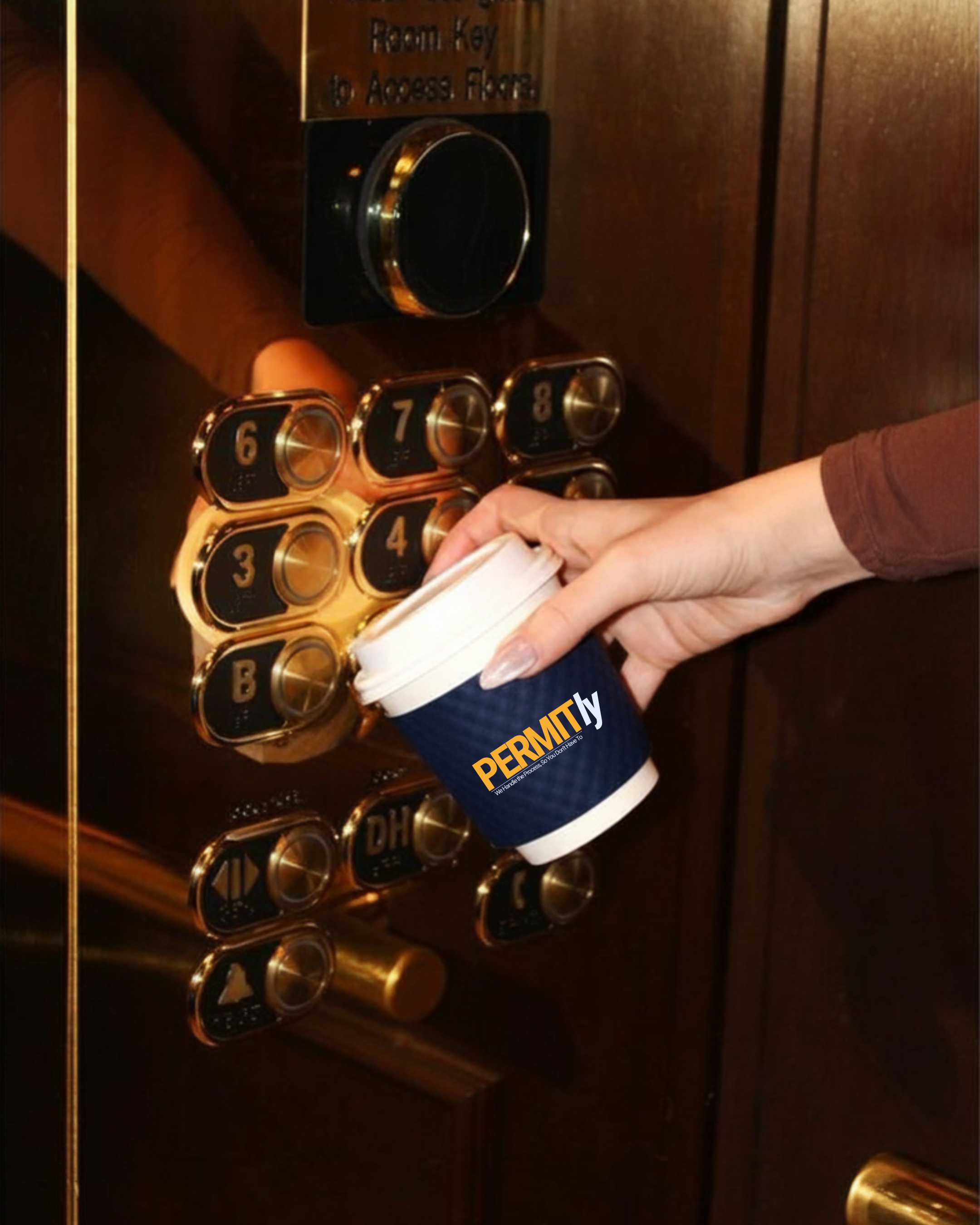 A person holding a coffee cup marked 'PERMIT' inside an elevator with gold-colored buttons.
