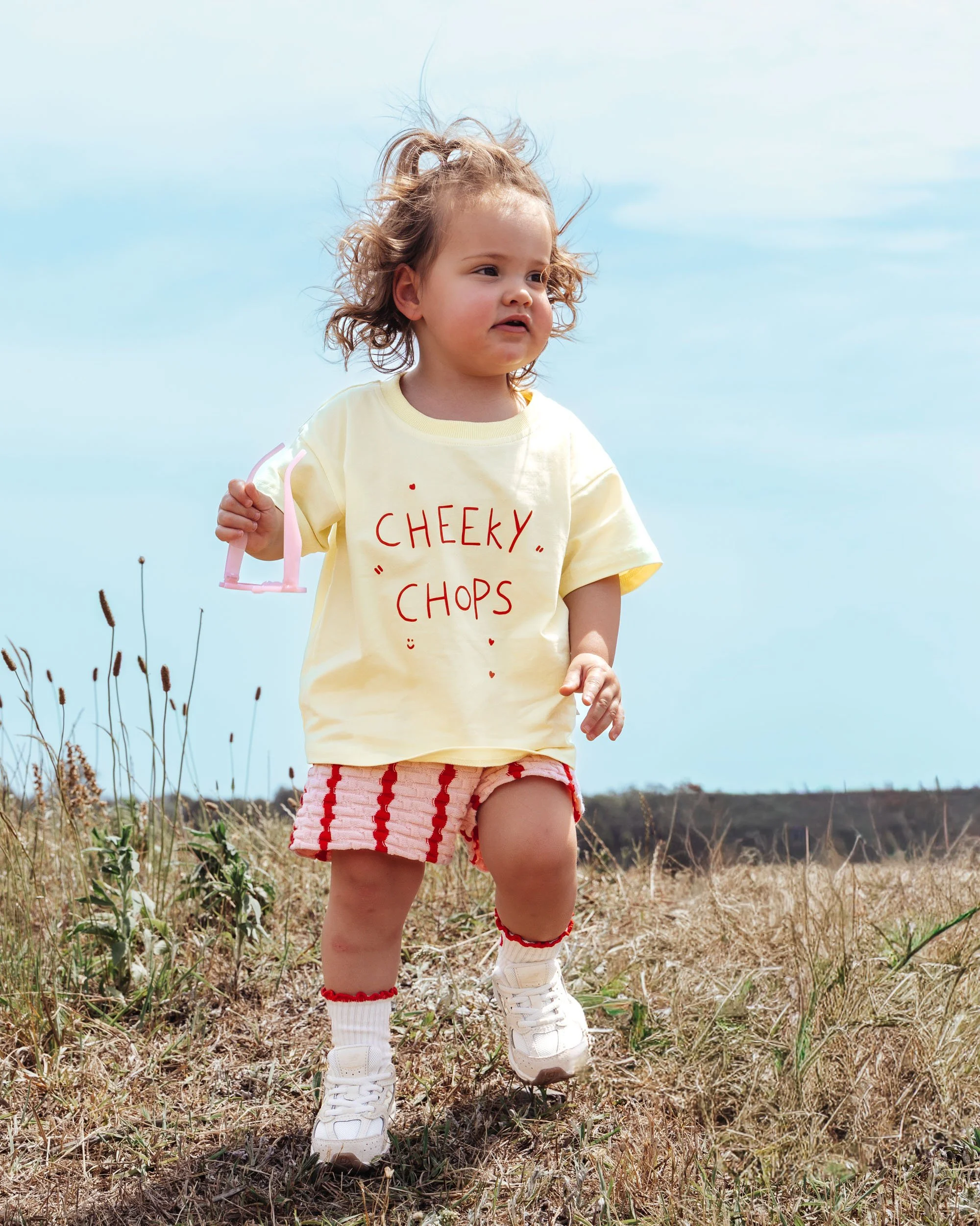 Kids fashion campaign photography in outdoor setting with natural light and soft tones