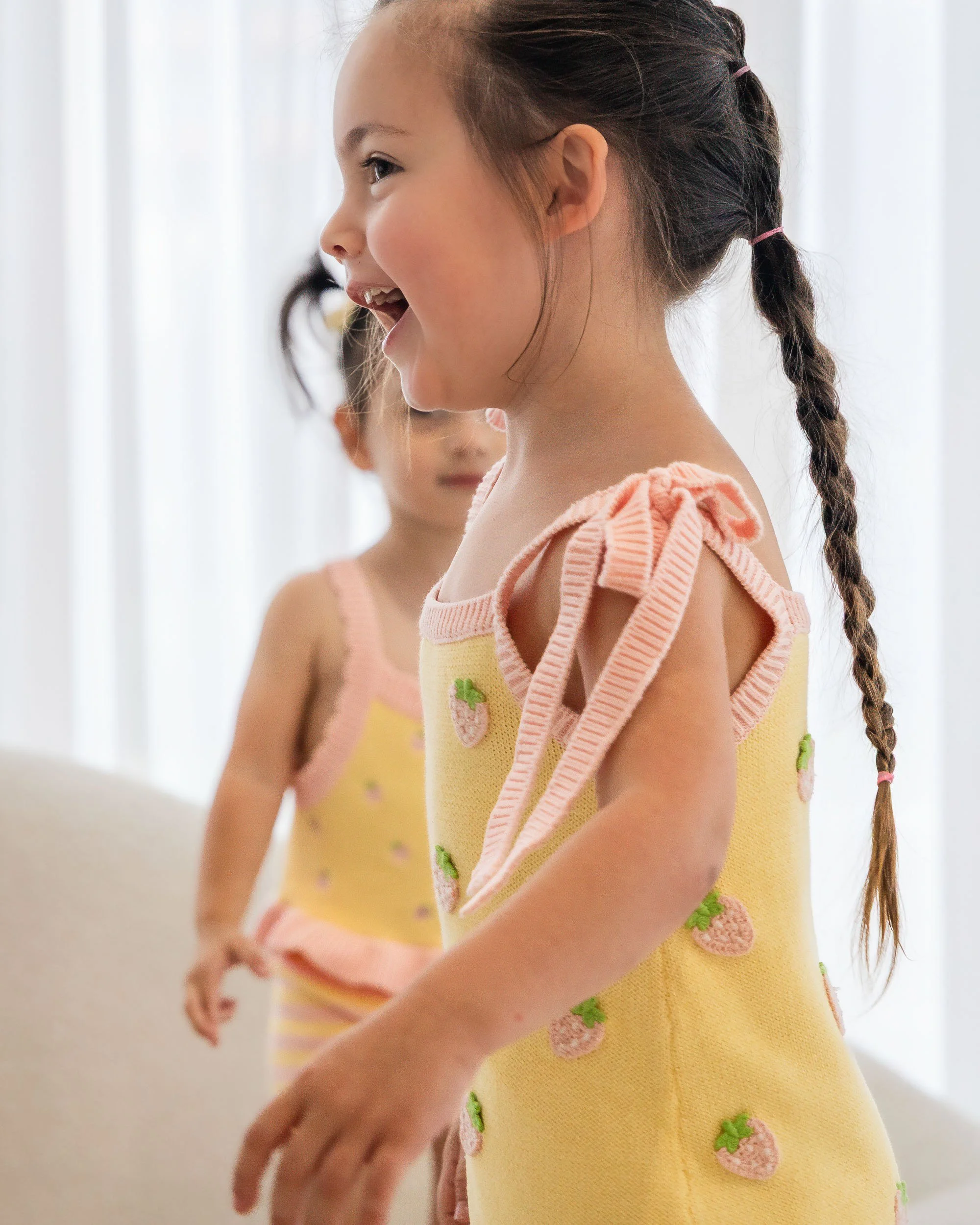 Kids fashion campaign photography in studio with soft natural light and playful styling