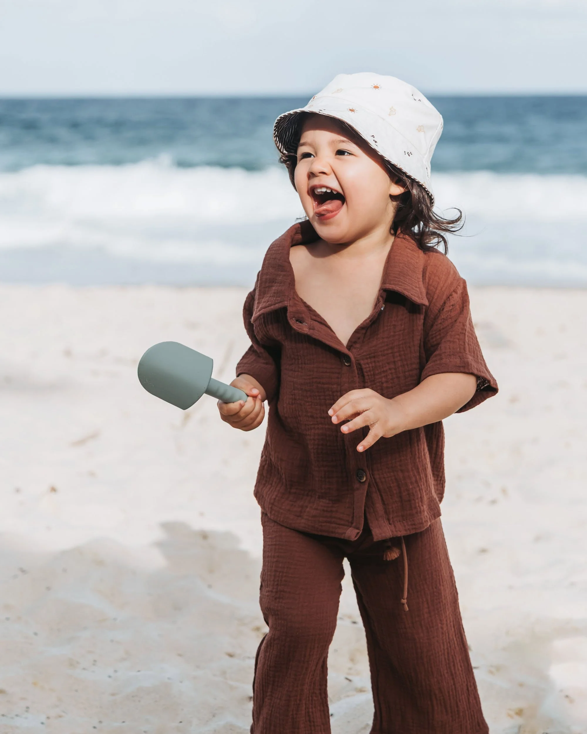 Playful child moment on the beach captured by Sydney family photographer Georgie Meadows Creative  