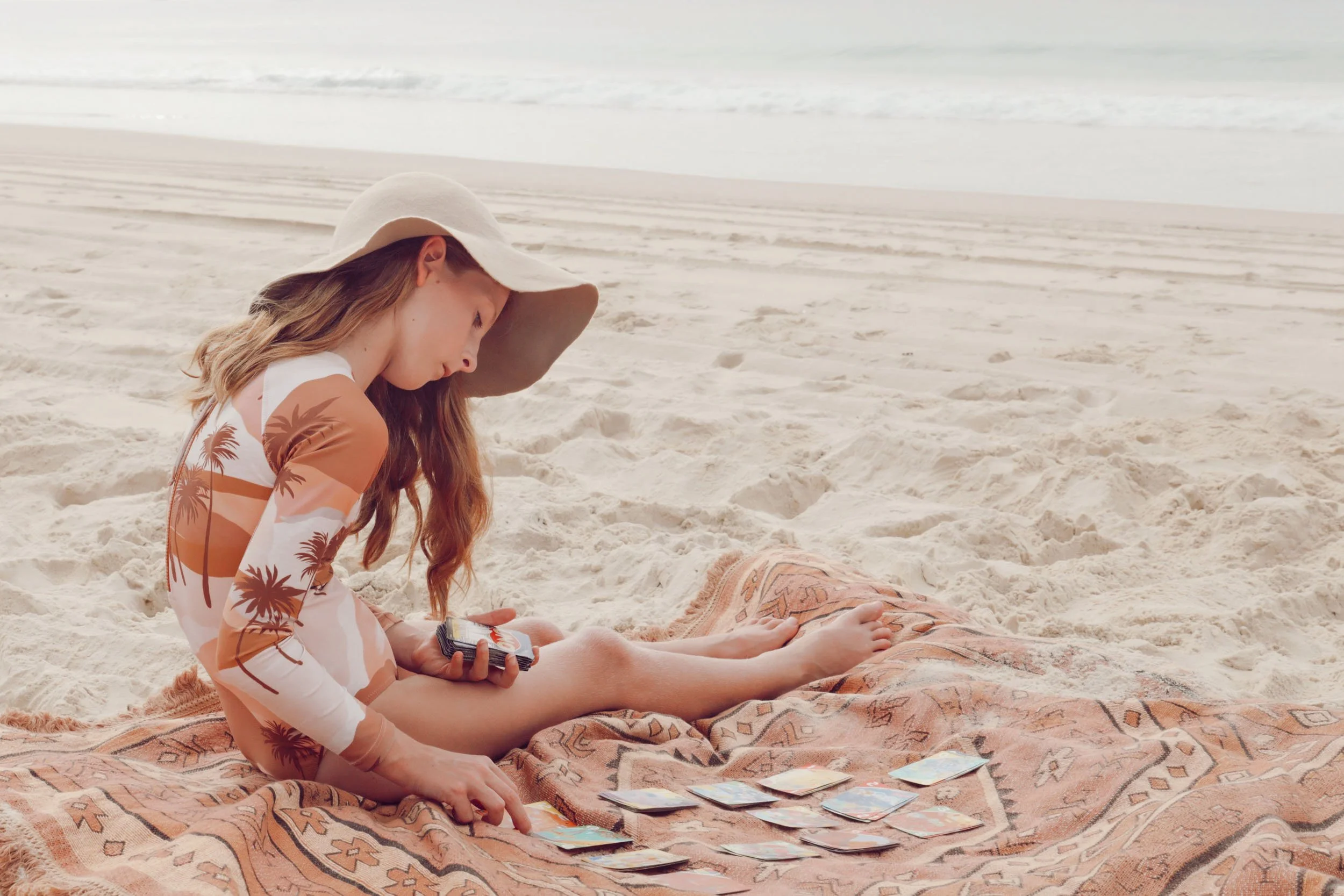 Child sitting together on the beach by Georgie Meadows Creative Sydney  