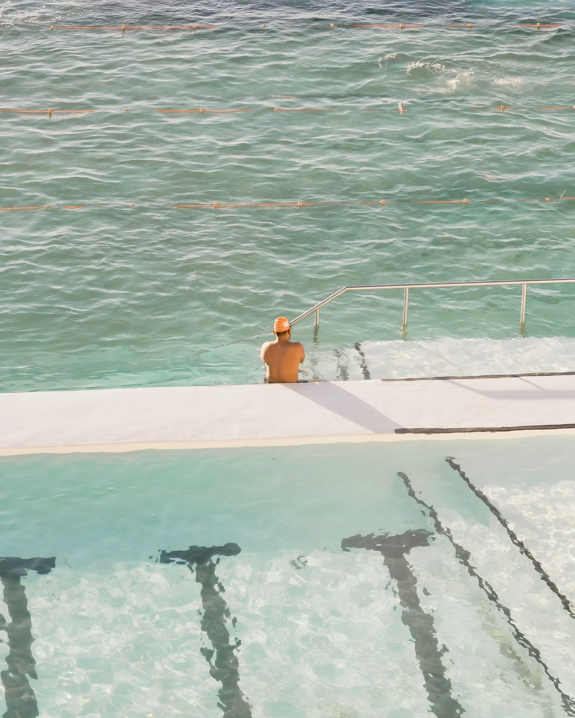 Sydney ocean pool photography with swimmer and turquoise water from above