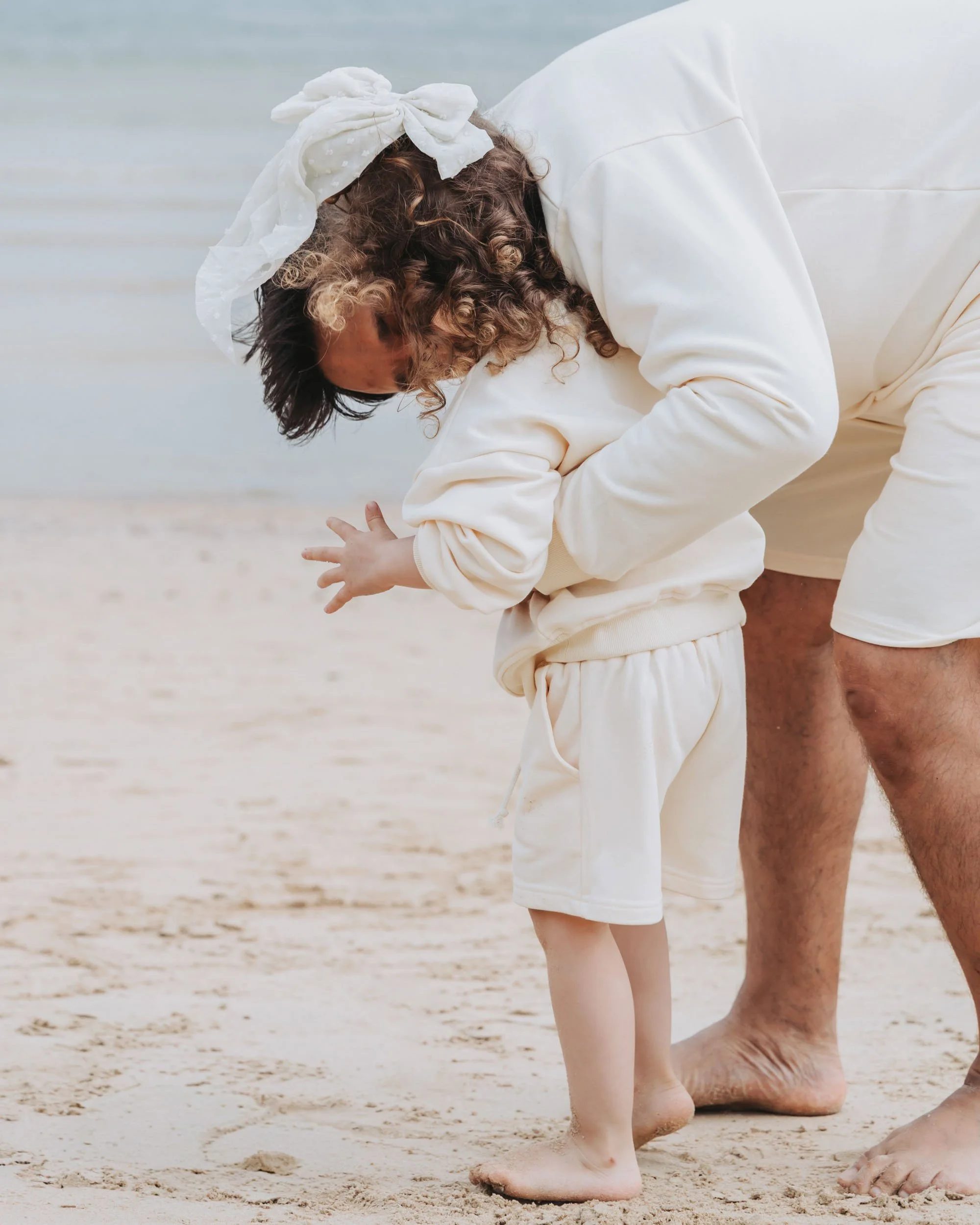 Father and child playing at the beach captured by Sydney family photographer Georgie Meadows Creative  
