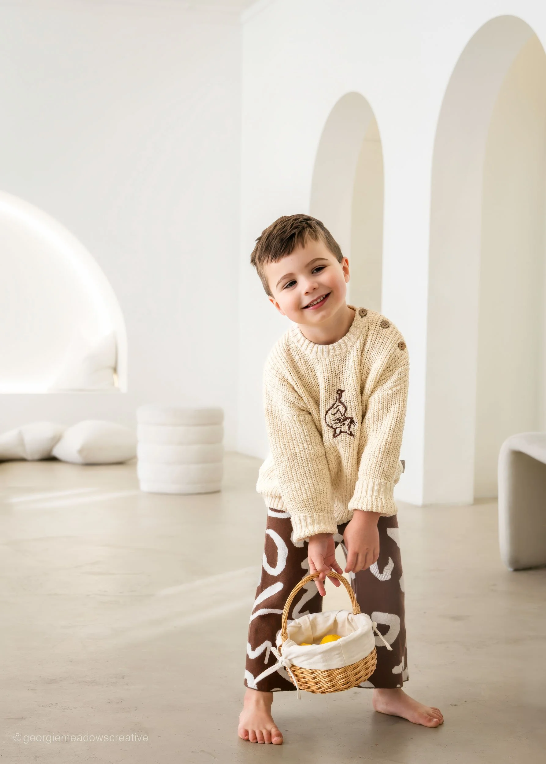 Kids fashion campaign photography in neutral studio setting with soft natural light