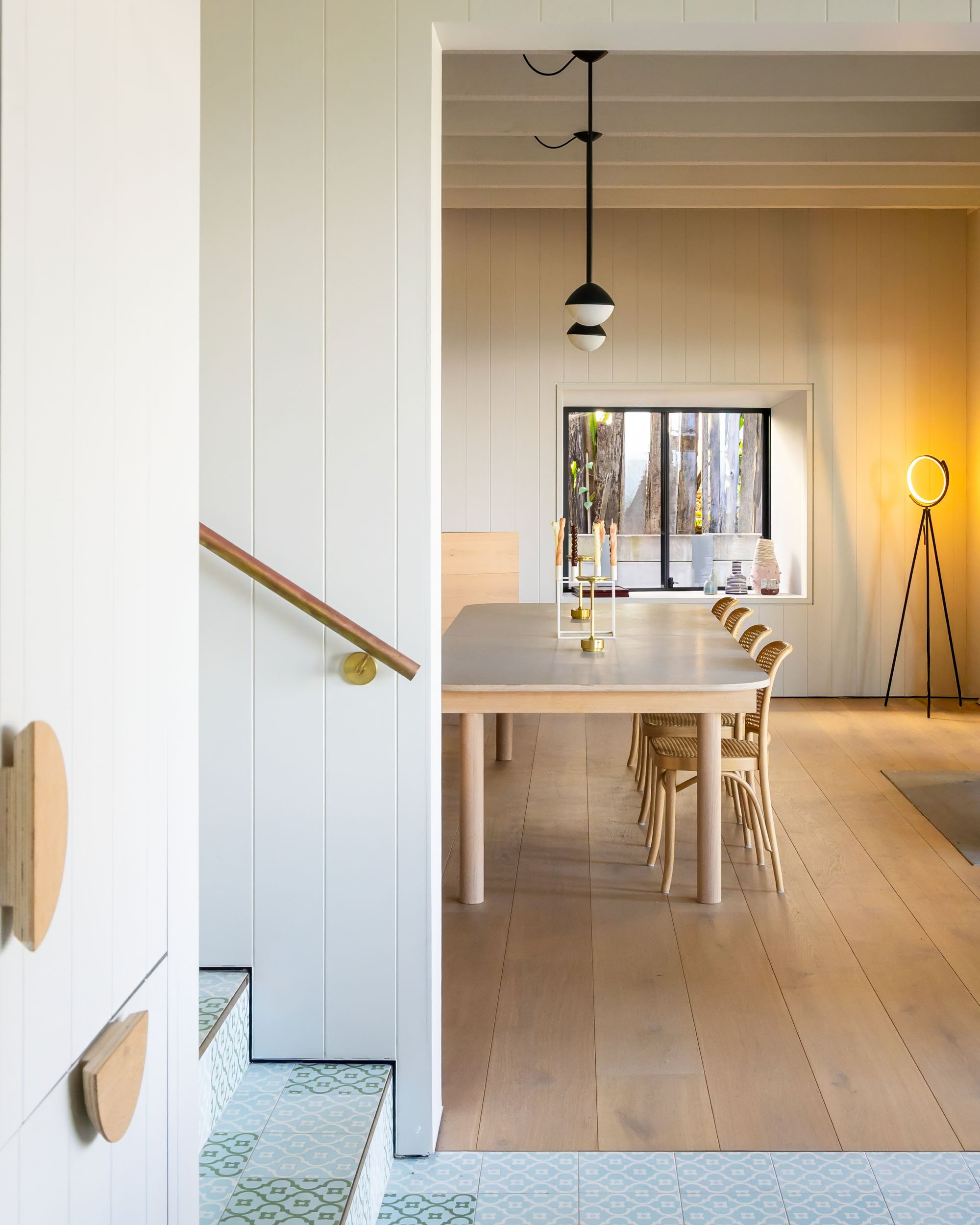 Light-filled interior photography of modern dining space with timber furniture and soft natural light