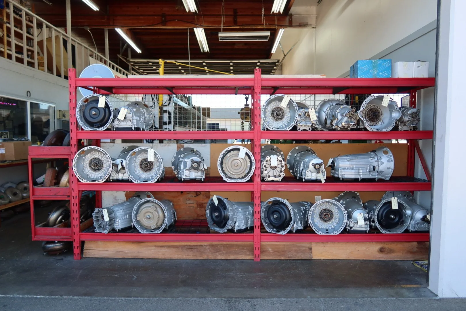 Shelf containing automotive transmissions in a workshop.