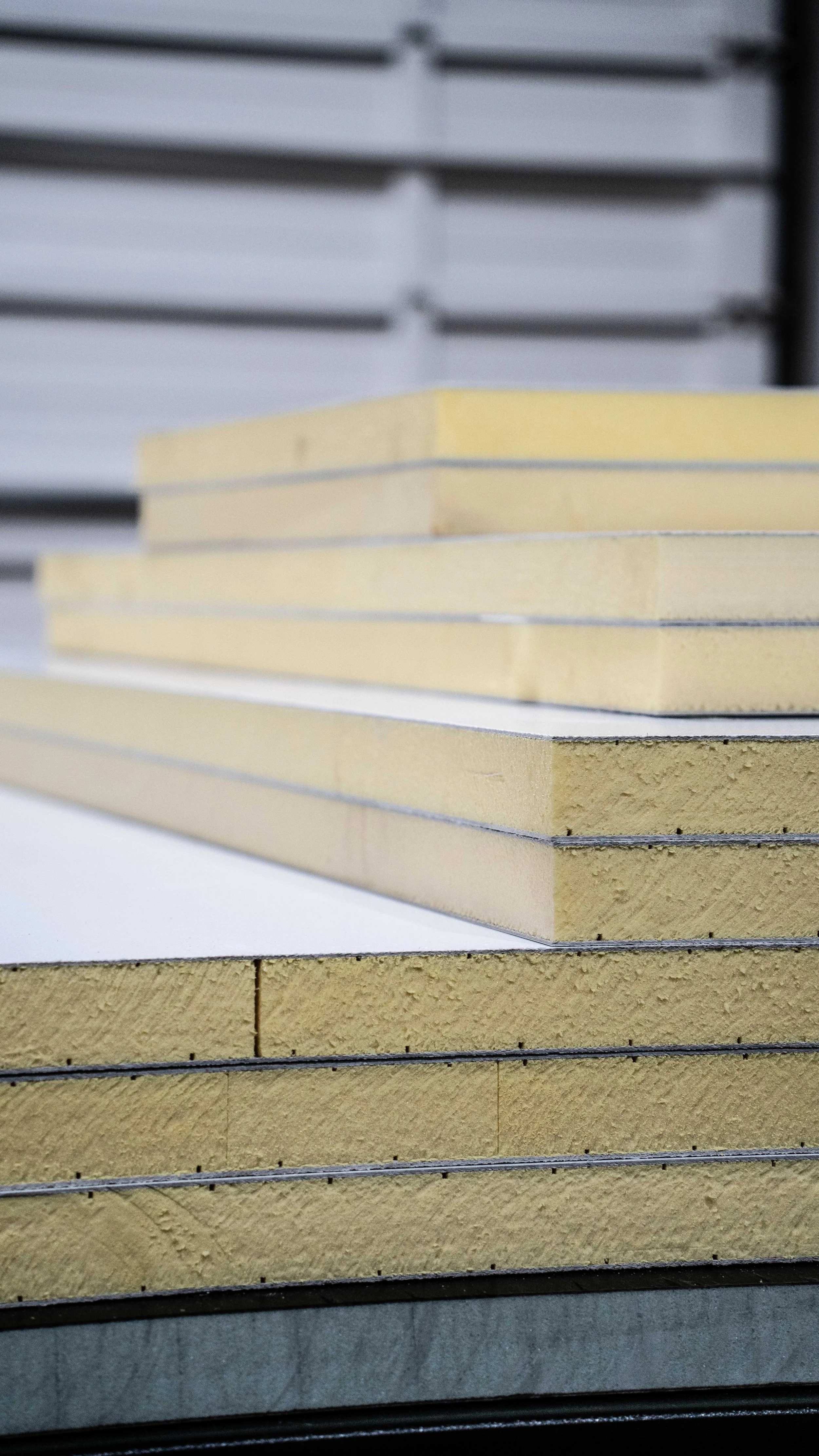 Close-up of stacked construction materials, including composite panels