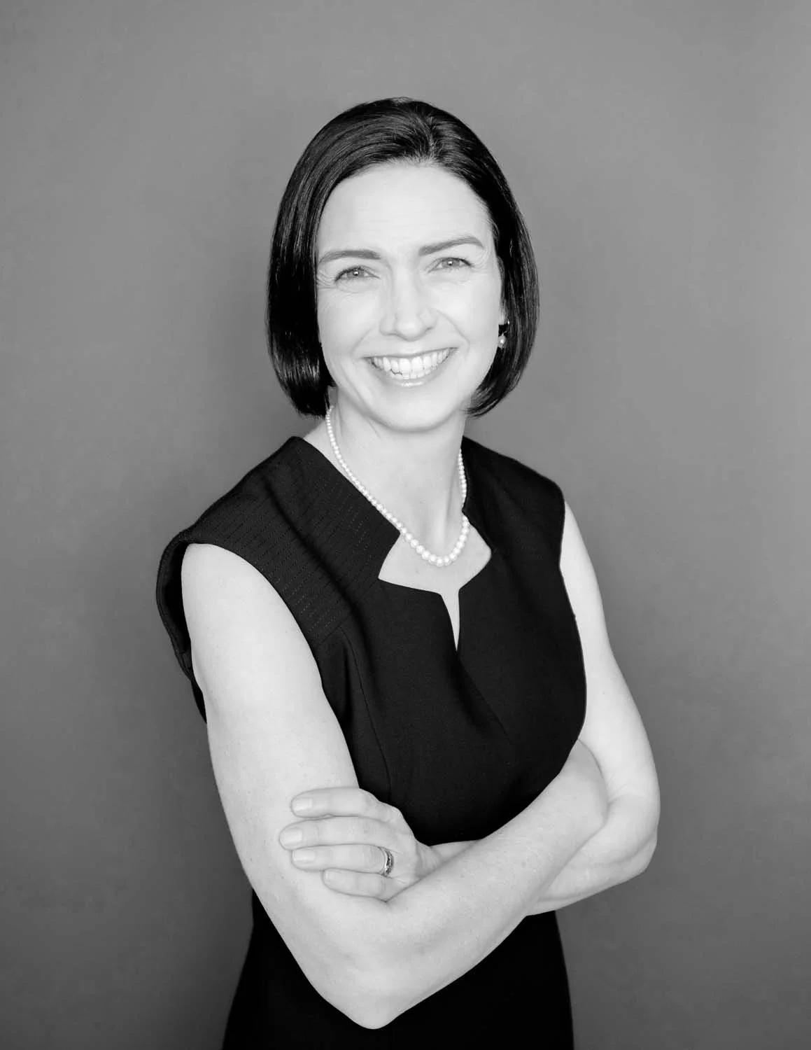 Judge Adrian Brown in black and white image, black dress with pearls