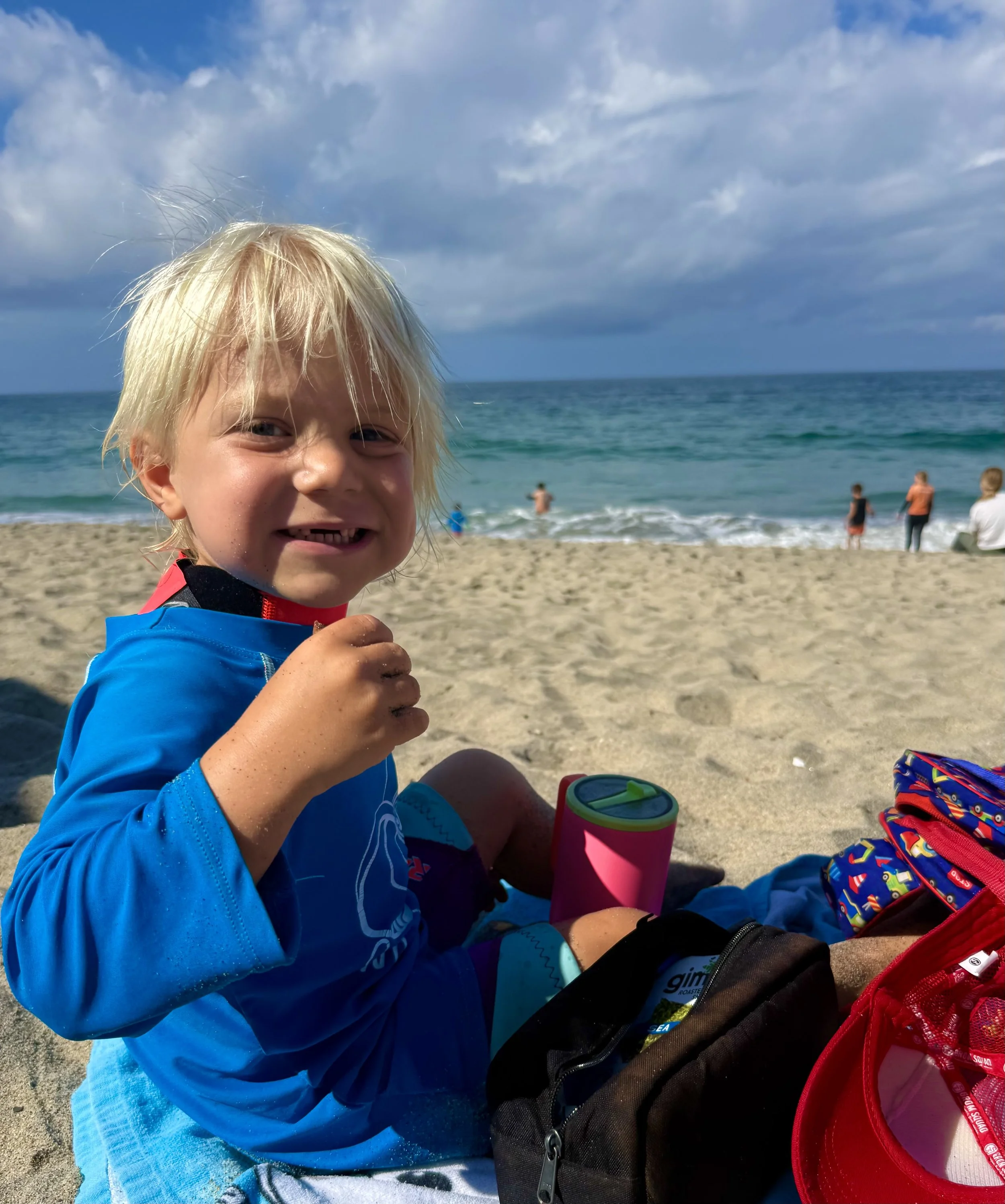 child at surf camp, neurodiverse surf therapy, special needs surf camp