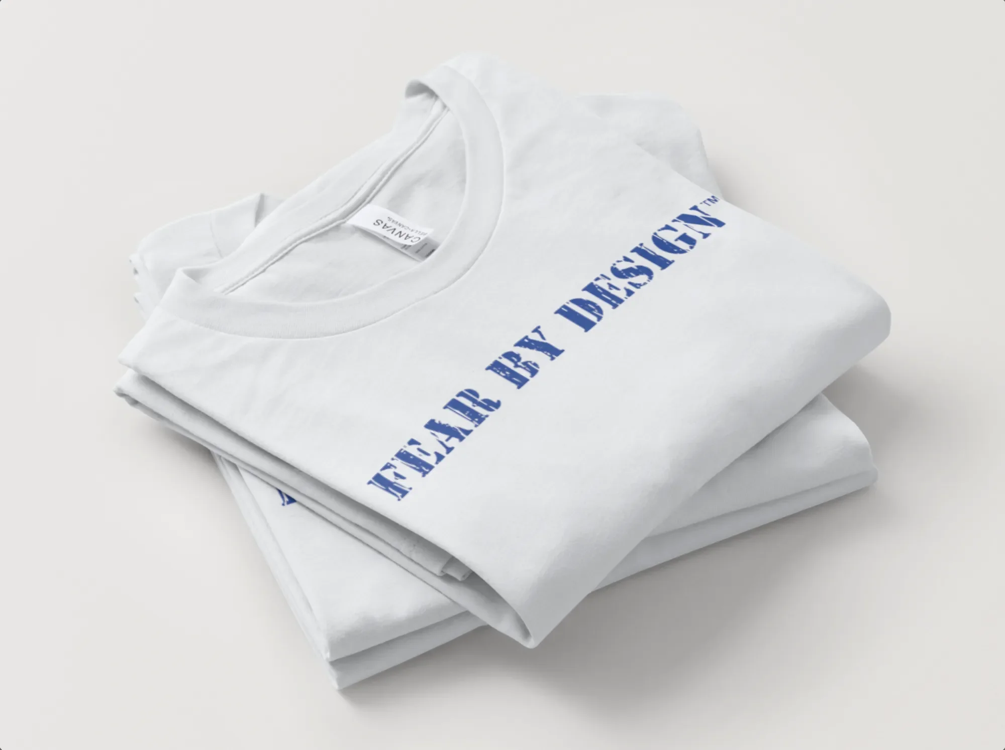 stack-of-folded-White-Shirts-printed-with-Fear-By-Design.webp