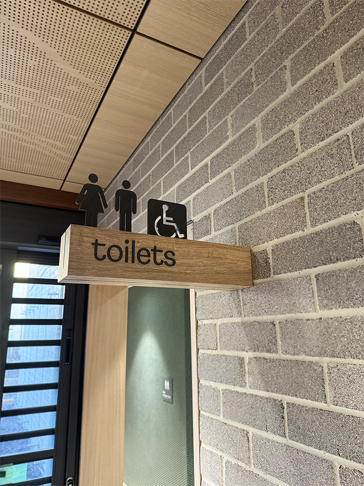 Custom designed timber and acrylic wayfinding signs