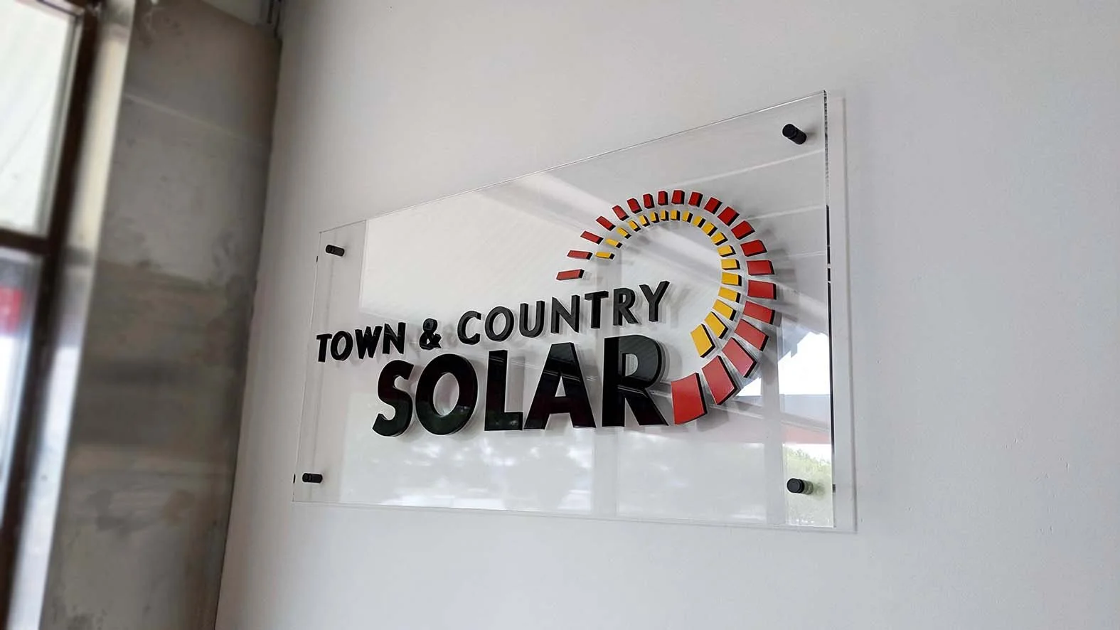 Wall mounted clear acrylic with dimensional acrylic logo