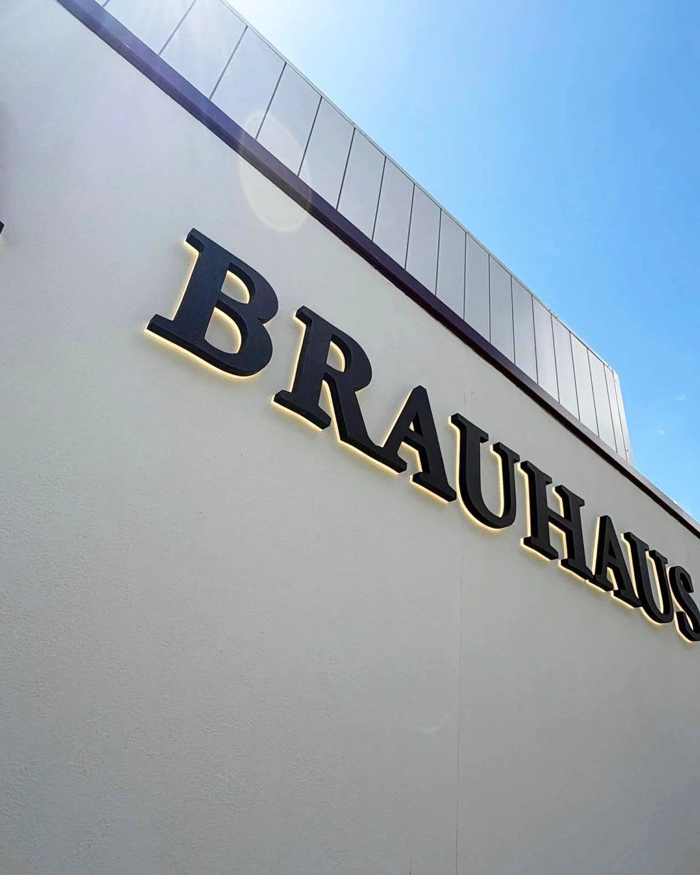 B R A U H A U S &bull; Illuminated back-lit logo signage with Corten letterset, bringing the building to life day and night. A perfect blend of modern glow and rustic charm. #haynessigns