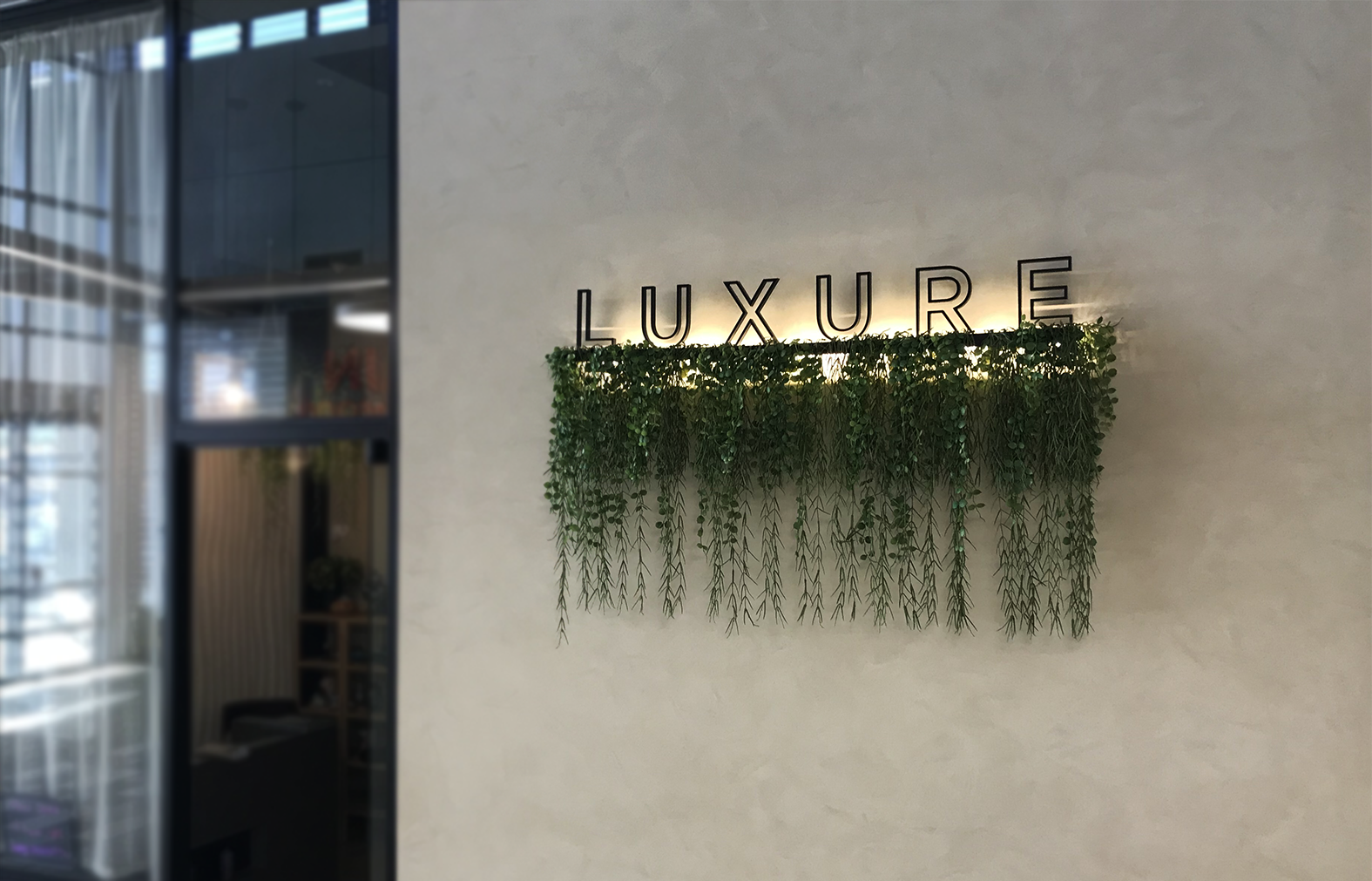 Wall mounted gloss black acrylic logo with illumination