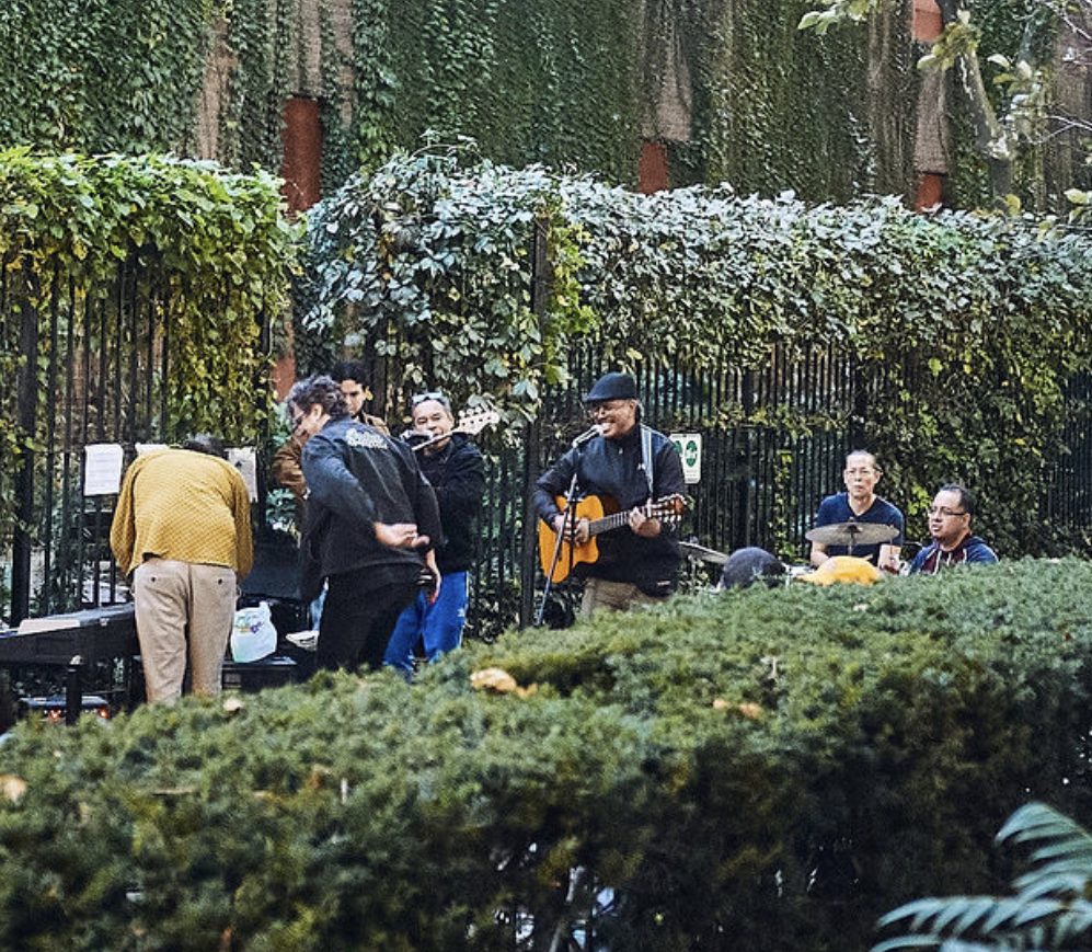 A group of musicians performing in a garden