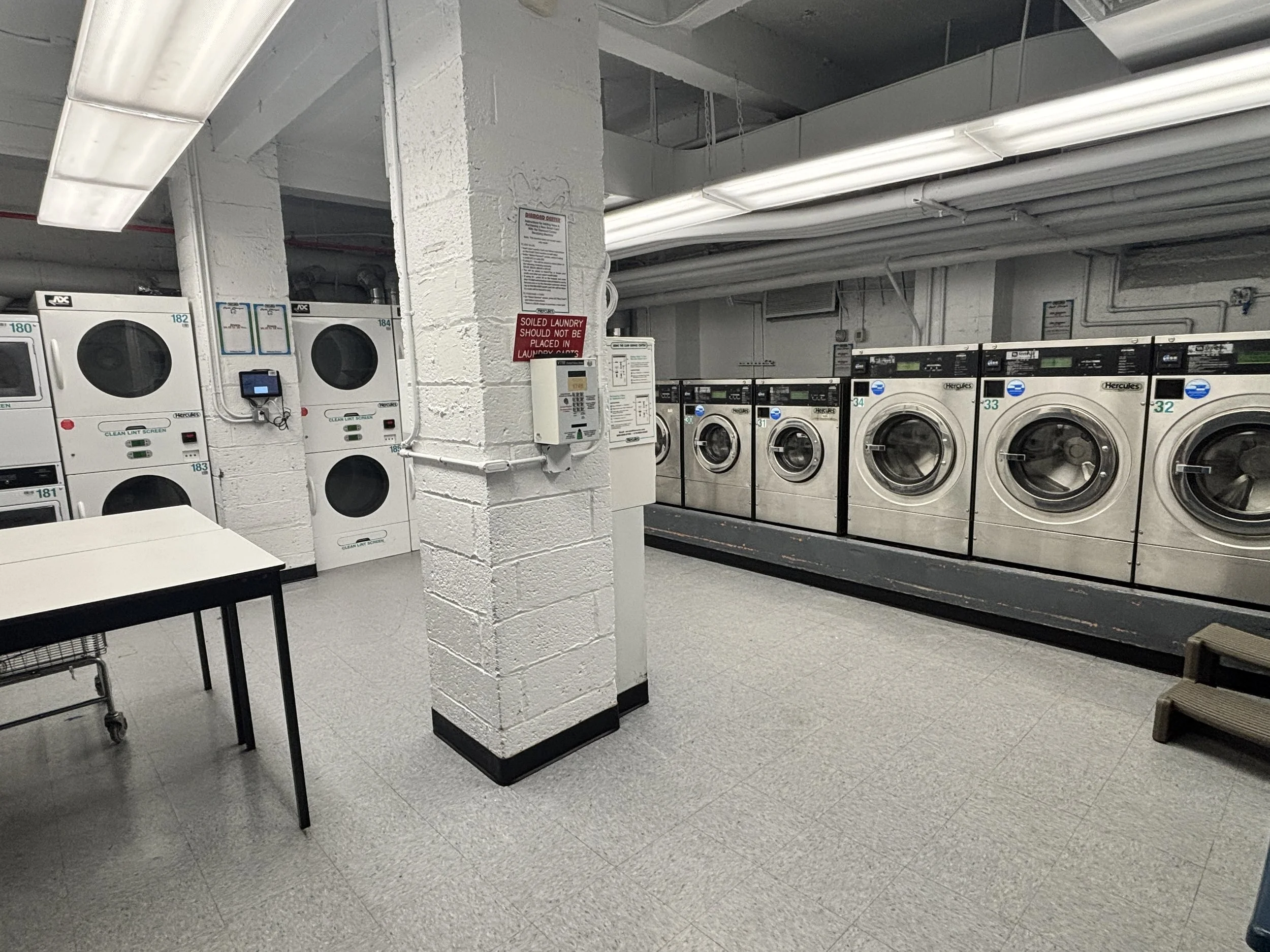 A space with laundry machines and dryers
