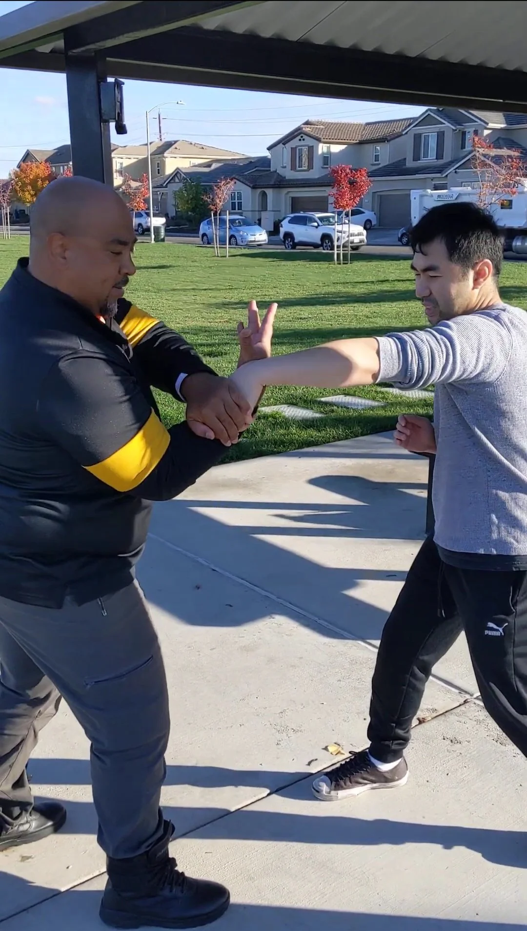 Two men practicing self-defense grabbing techniques