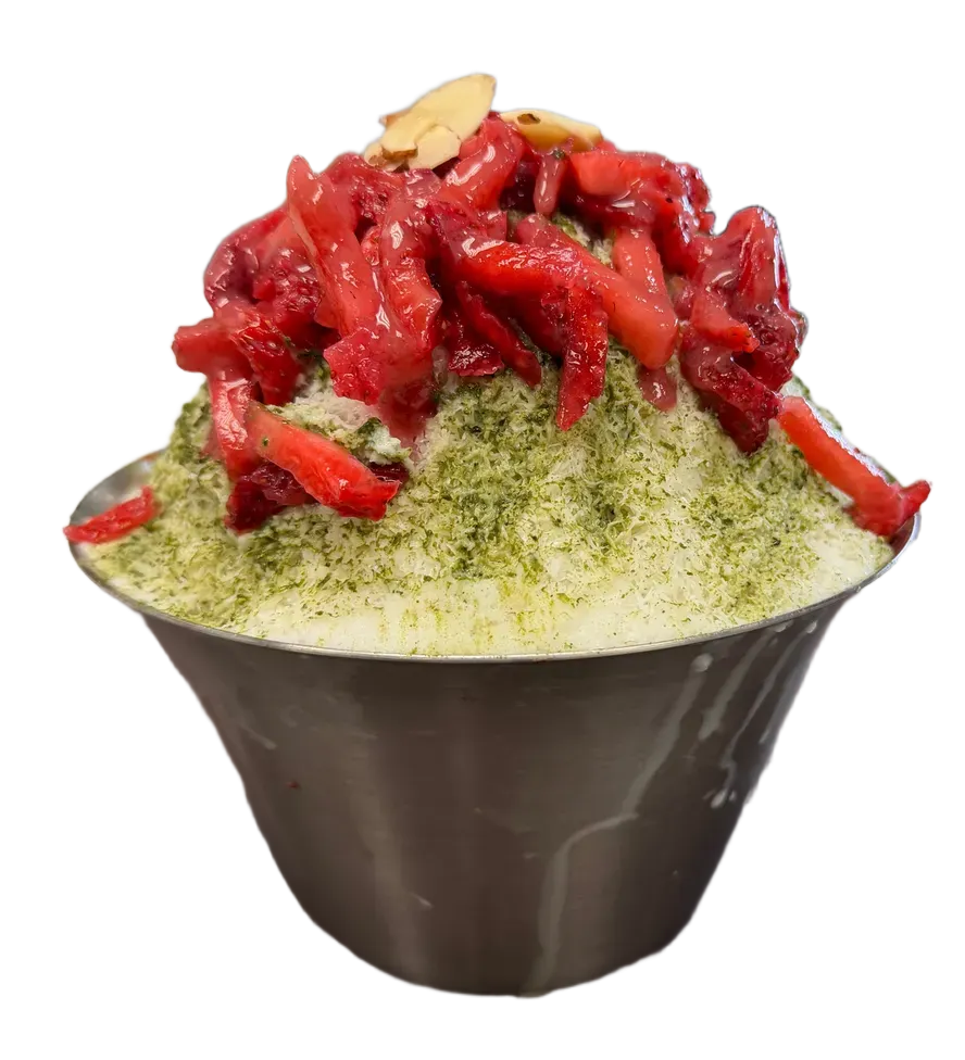 A bowl of shaved ice topped with strawberries and matcha.