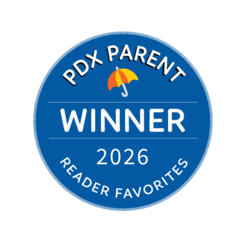 Blue circular badge with white text that says 'PDX Parent Winner 2026 Reader Favorites' and a small yellow umbrella icon.
