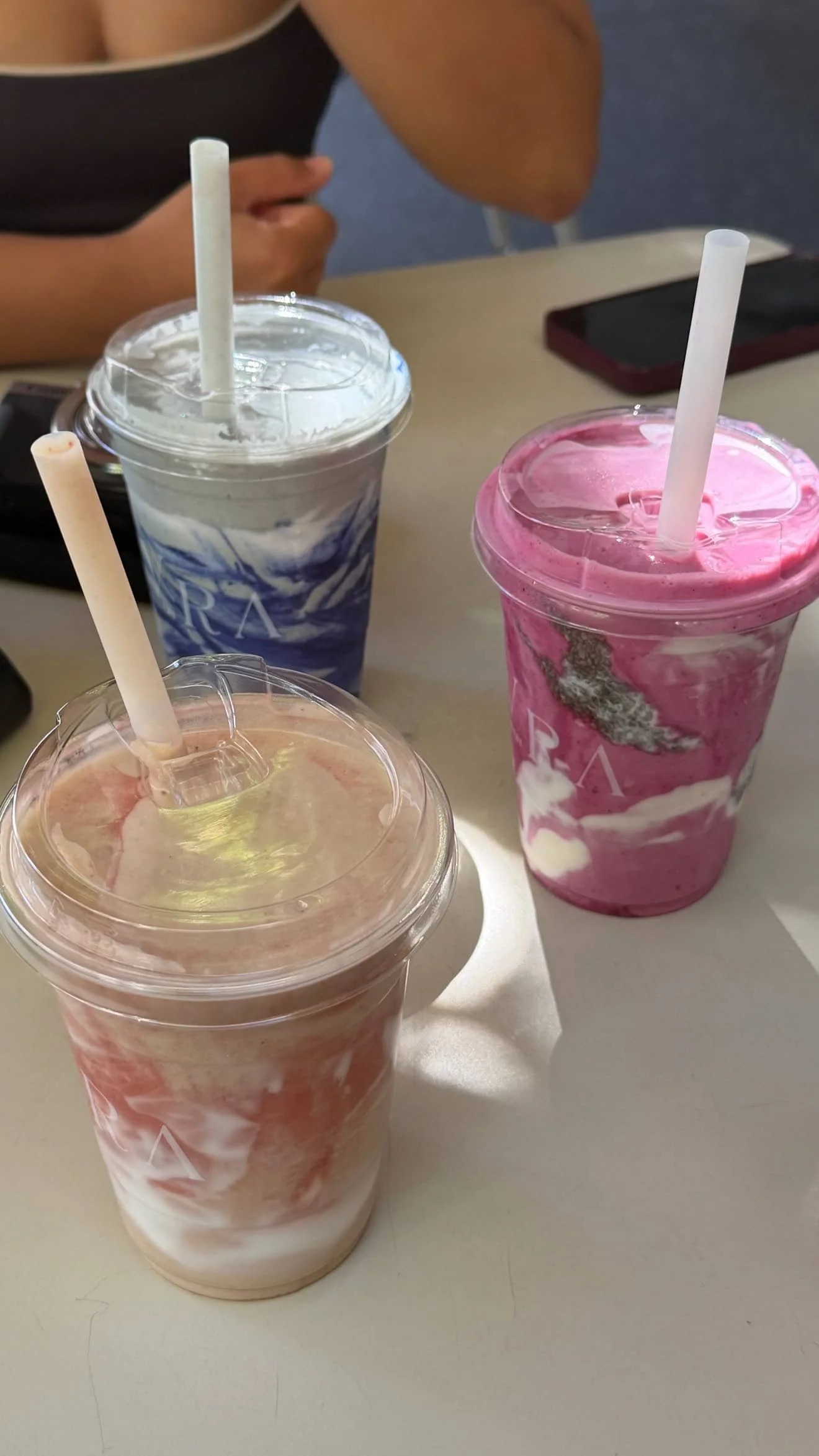 3 colorful drinks on a table.