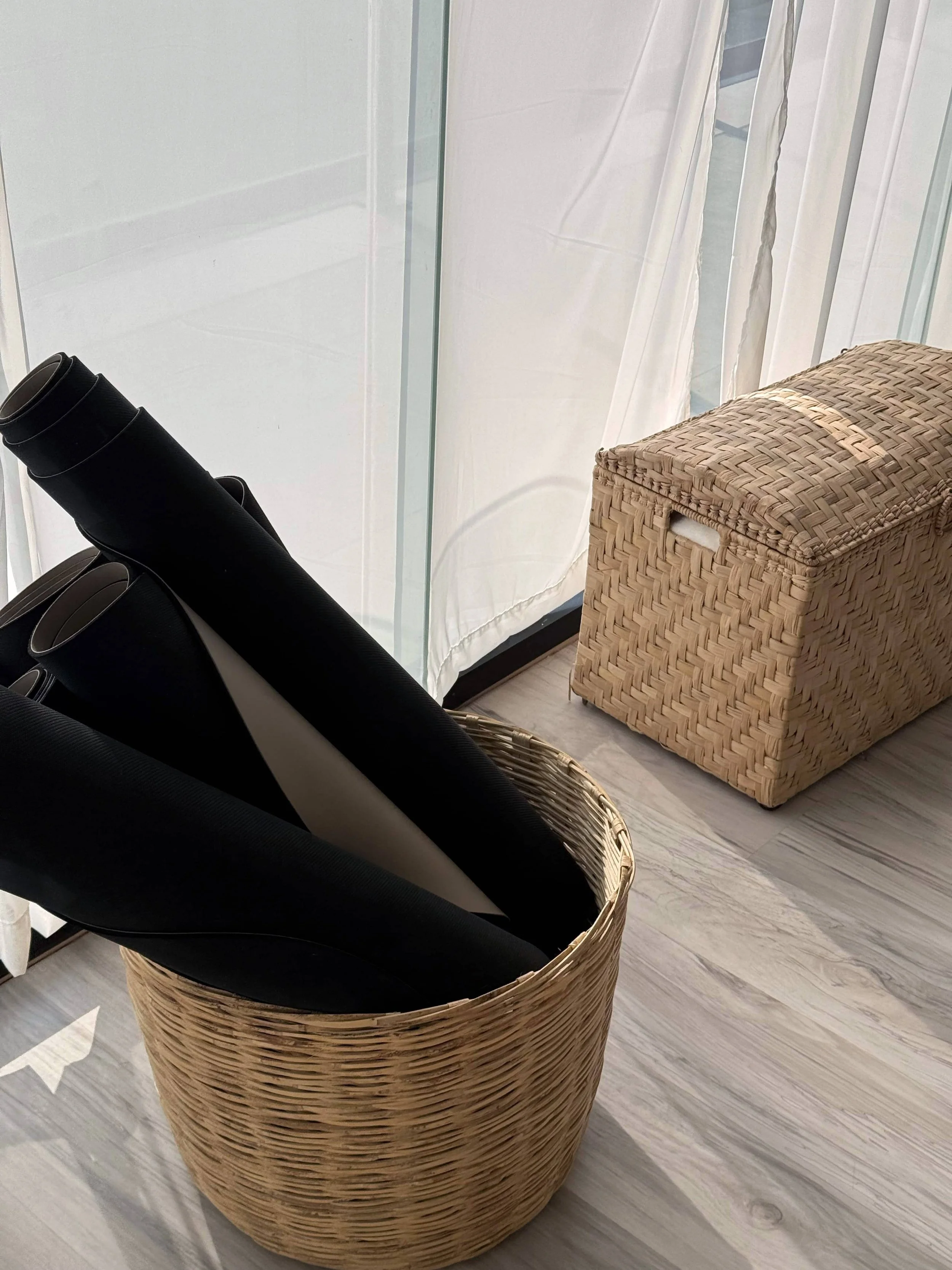 Yoga mats in a basket.