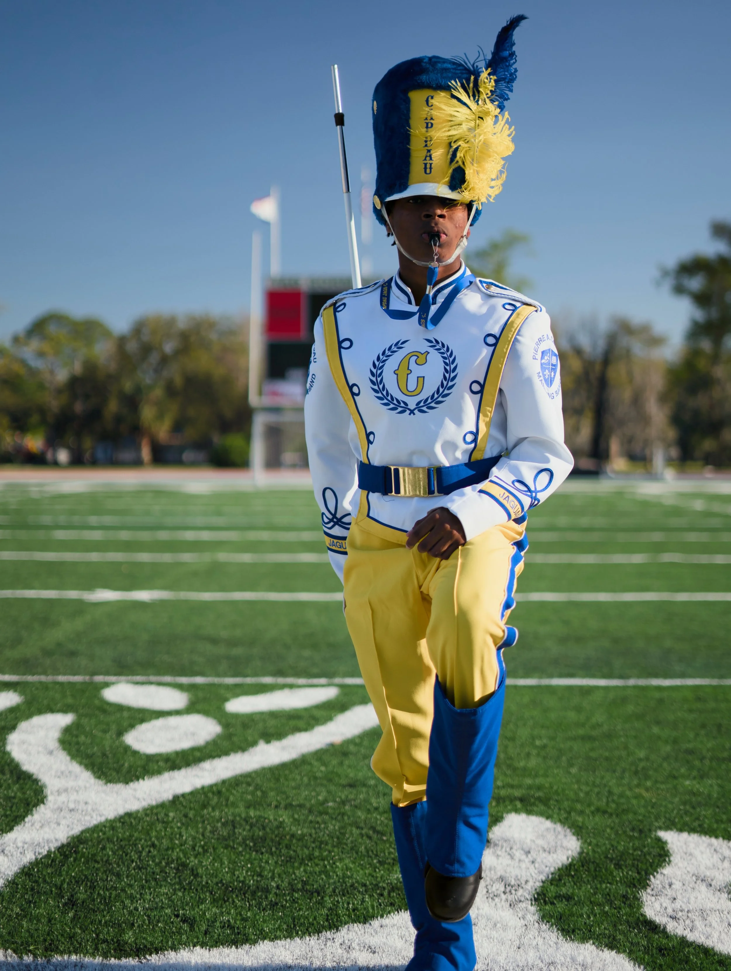 Marching band drum major in uniform on a football field — school portrait photography New Orleans Crescent Lens