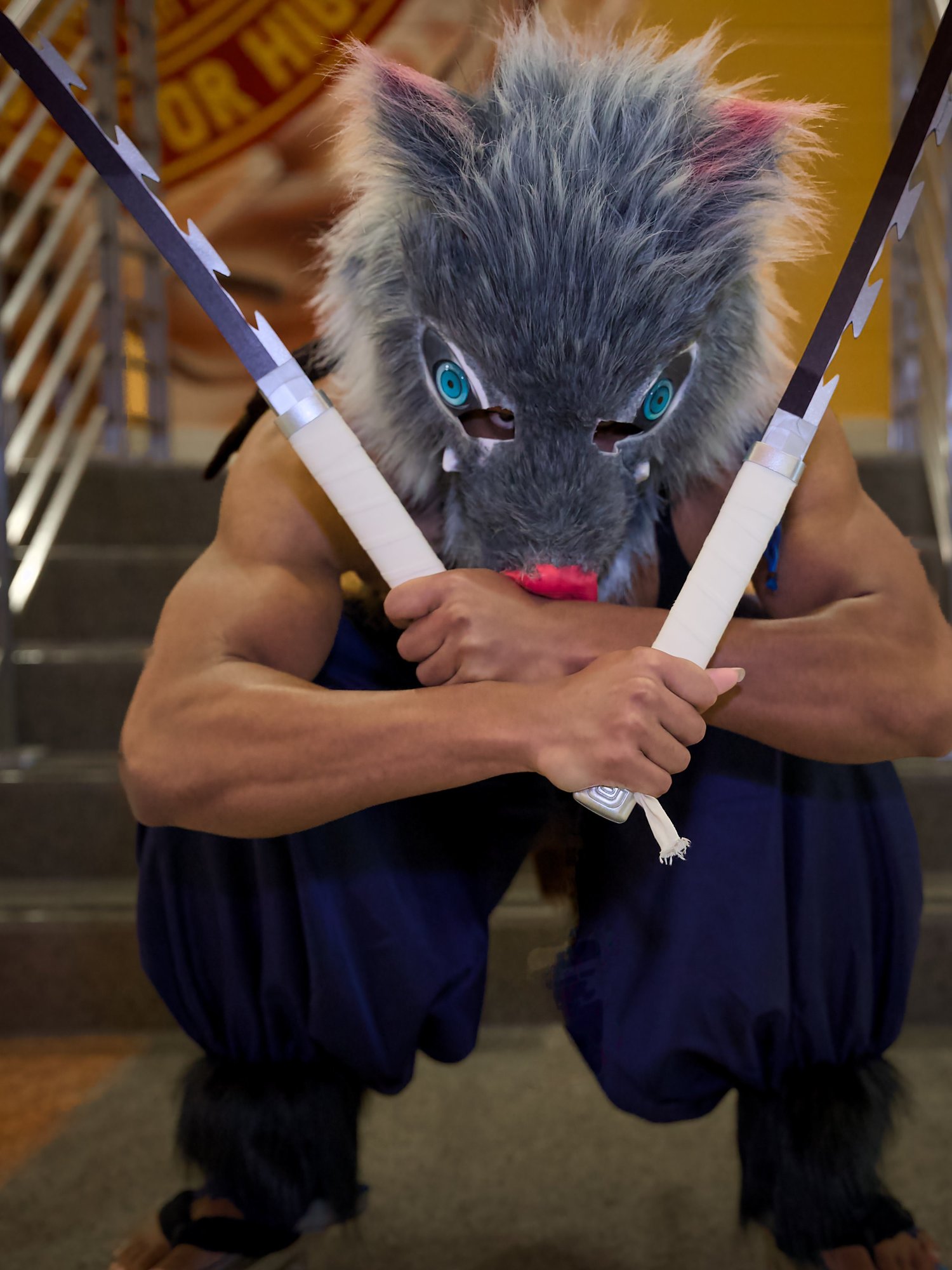 Inosuke cosplayer with crossed swords at Blerdfest