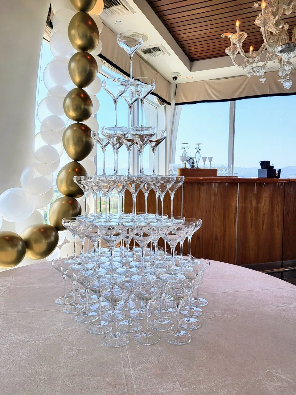 Bubles curated 6 tiered Champagne tower with elegant Prism glass coupes for client birthday 35th party