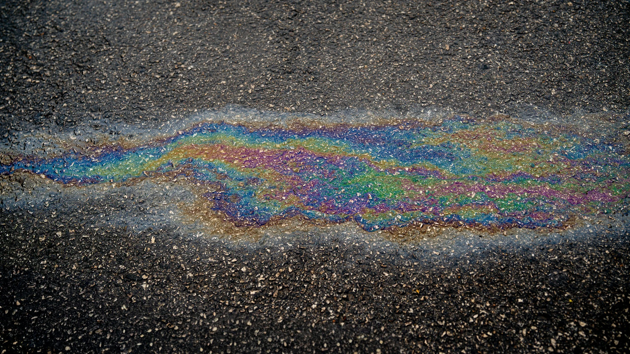 Rainbow-colored oil slick on asphalt.