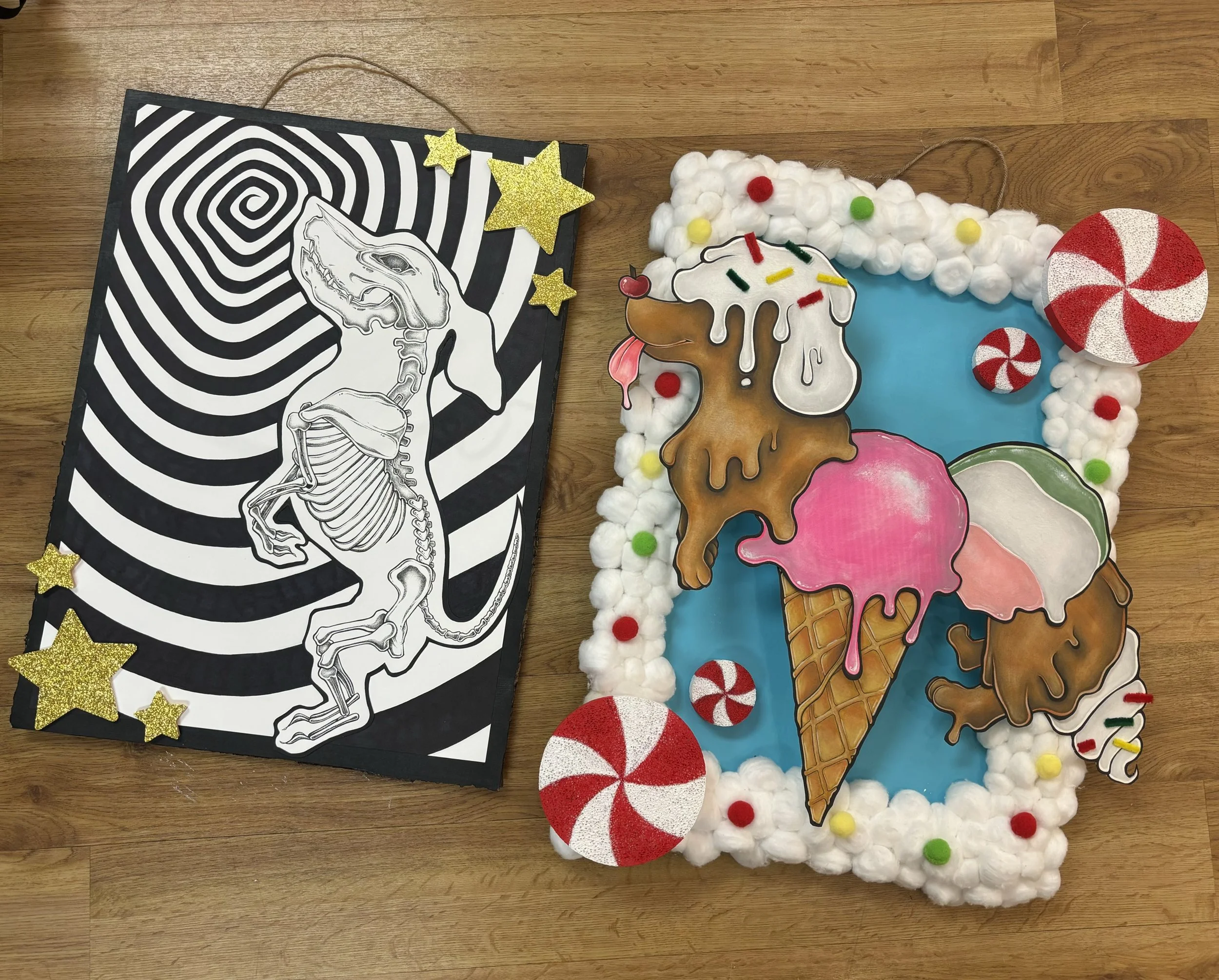 A mixed media art piece featuring a black and white printed illustration of a dinosaur skeleton on a spiral hypnotic background with gold star decorations, and a colorful ice cream themed display with cotton ball clouds, peppermint candies, and three ice cream cones with detailed cartoon-style scoops set on a blue background.