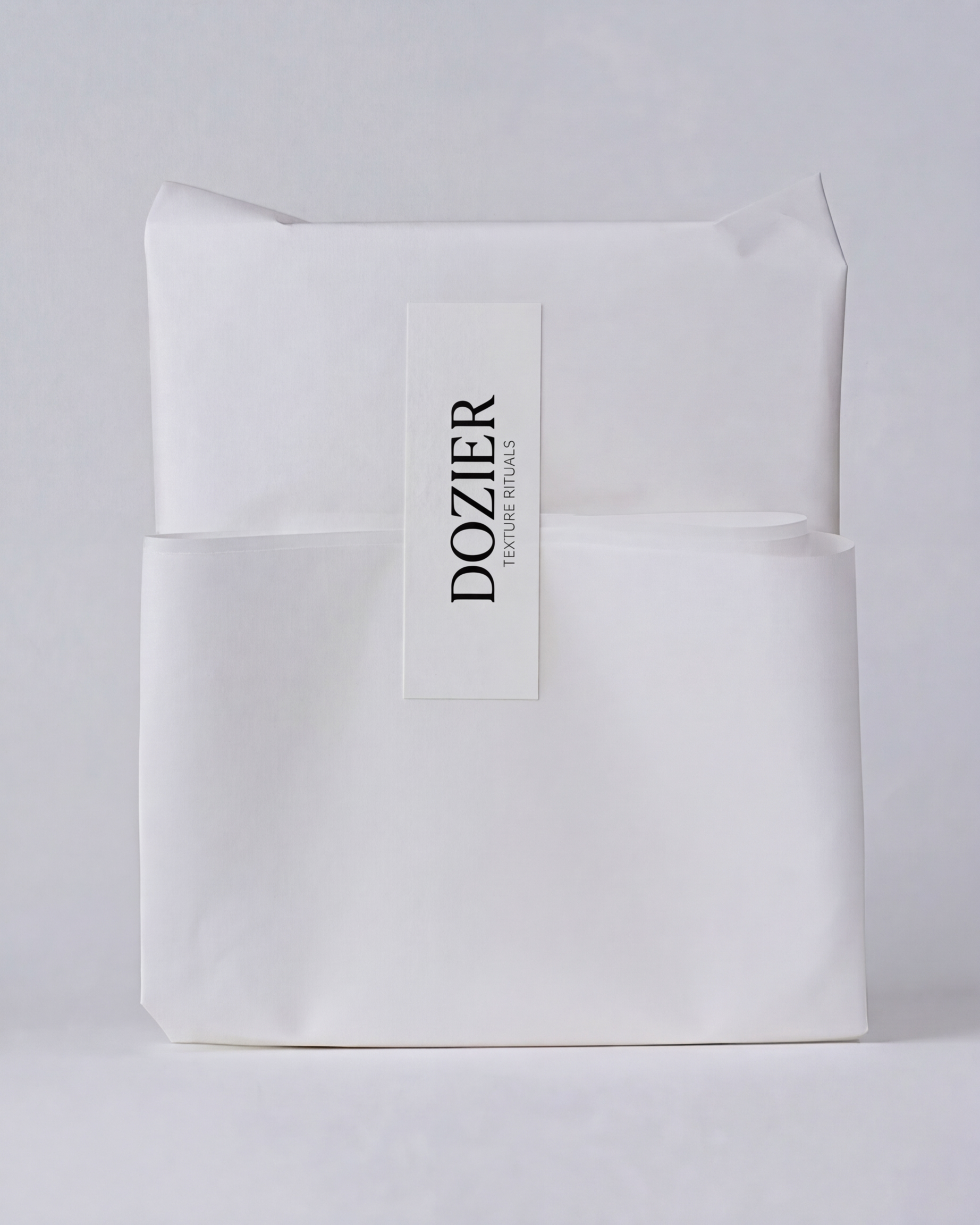 White packaging paper with a label that reads 'Dozier Texture Rituals' in black text.