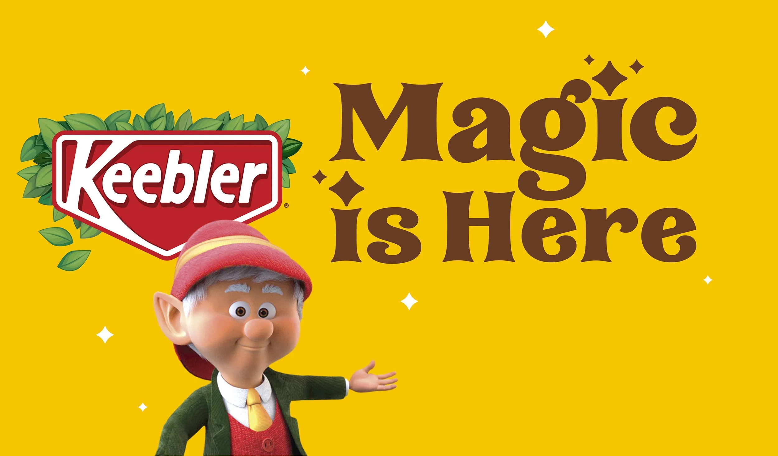 Animated character from the Keebler elves, with gray hair, wearing a red hat, green coat, yellow tie, and red vest, standing against a yellow background, with the Keebler logo and the words "Magic is Here".