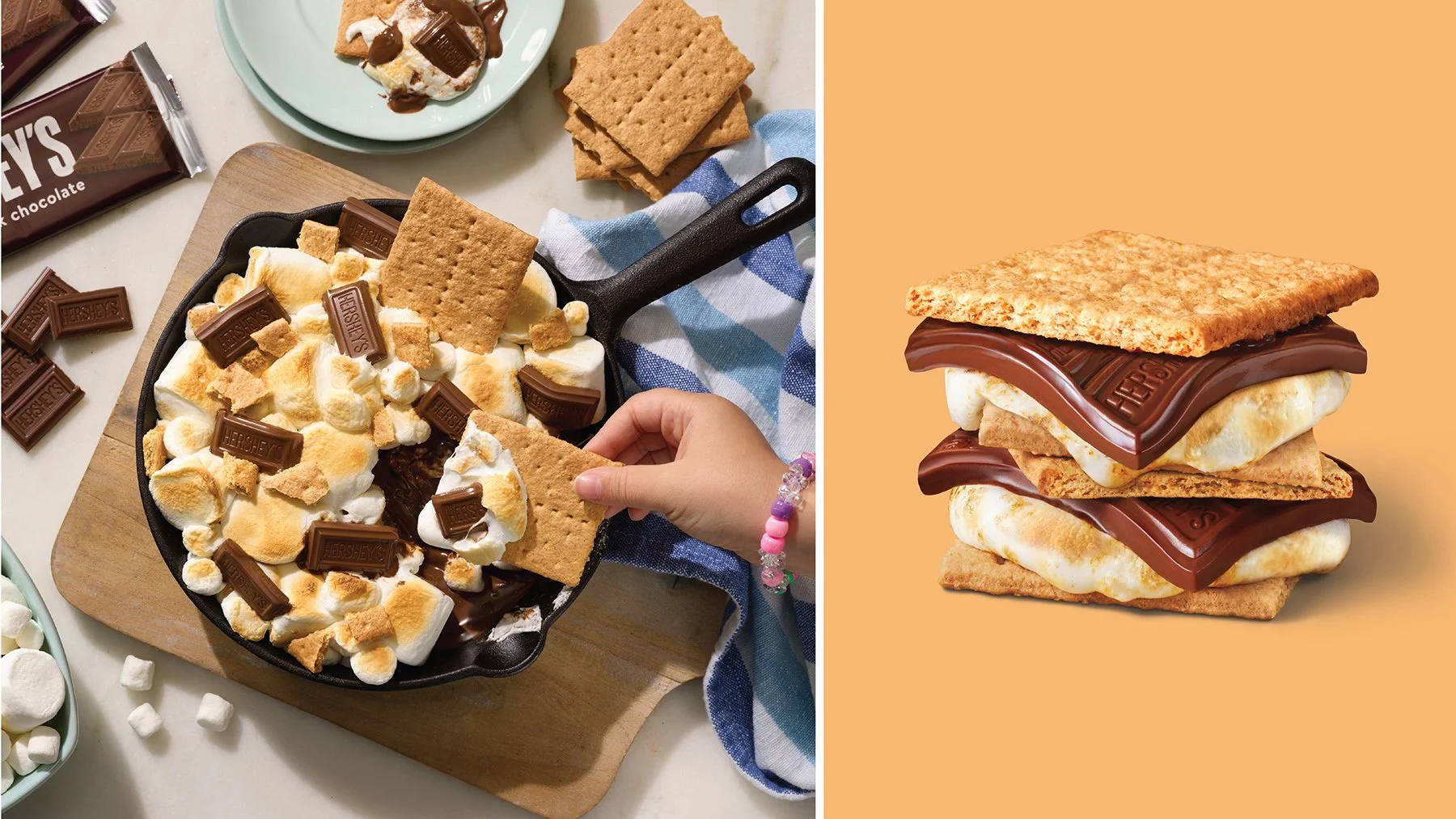 A side-by-side image showing a close-up of a s'mores dessert on the left and a creative food art piece resembling a s'mores sandwich on the right. The left shows a skillet with marshmallows, Hershey's chocolate bars, and graham crackers, with marshmallows and chocolate scattered around. The right shows a stylized stack of graham crackers, marshmallows, and Hershey's chocolate bars arranged to look like a layered sandwich.