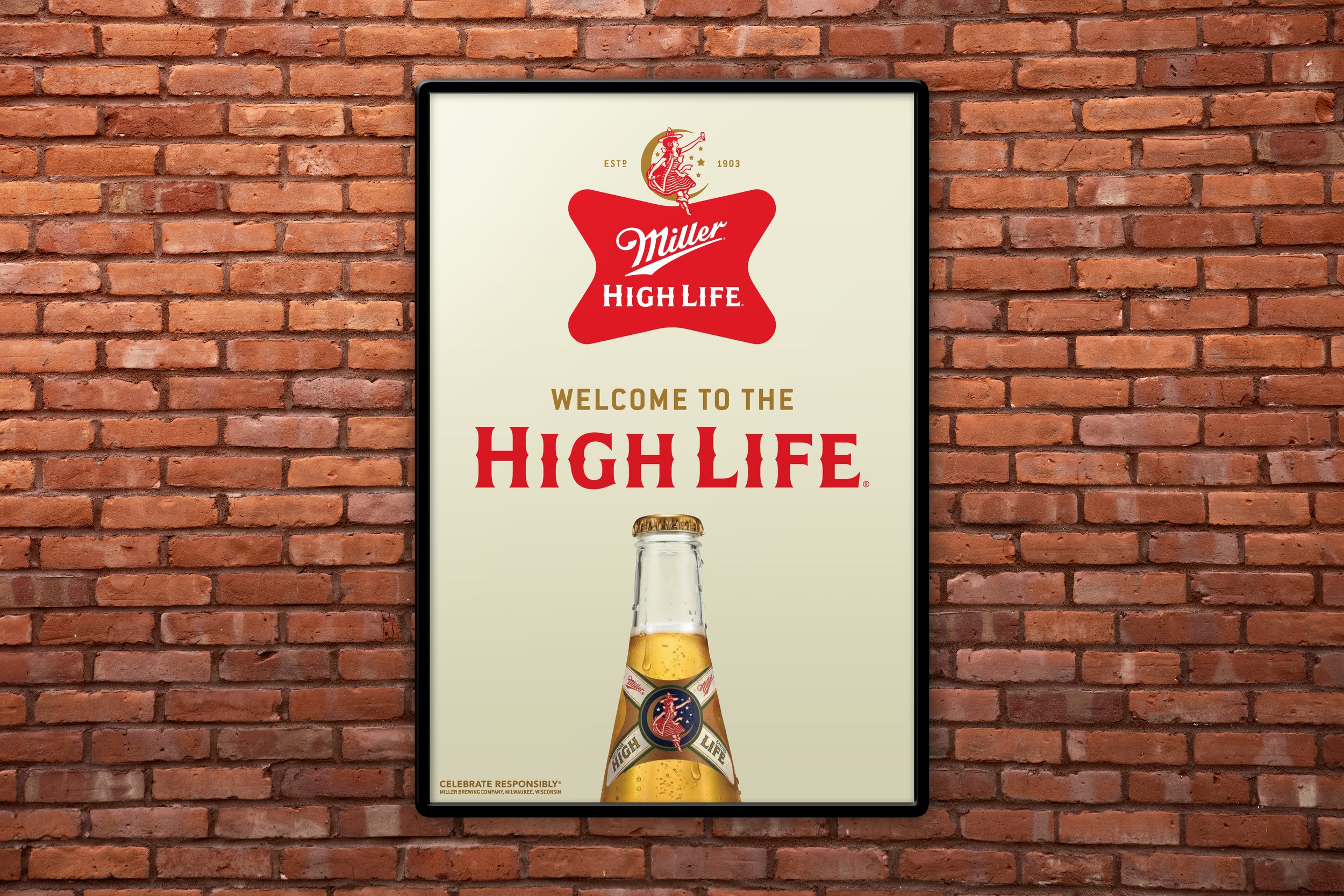A framed Miller High Life beer advertisement on a brick wall, featuring a bottle of Miller High Life beer and the brand's logo with a woman on a moon and stars, with the text 'Welcome to the High Life' and an endorsement to celebrate responsibly.