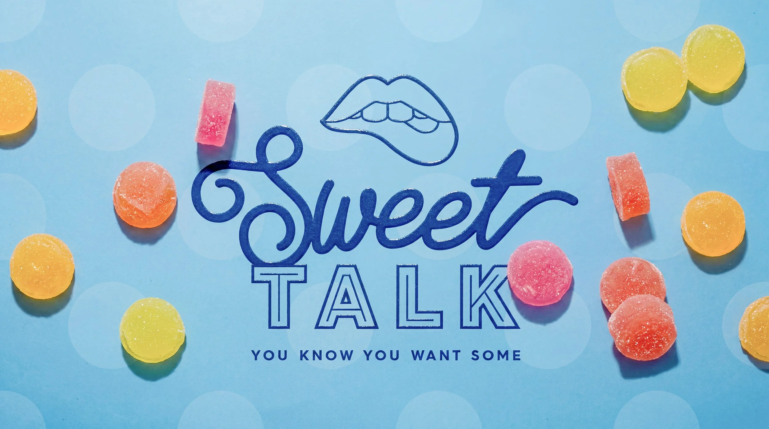 Colorful candy pieces surrounding a logo with lips and the text 'Sweet Talk', against a blue background.