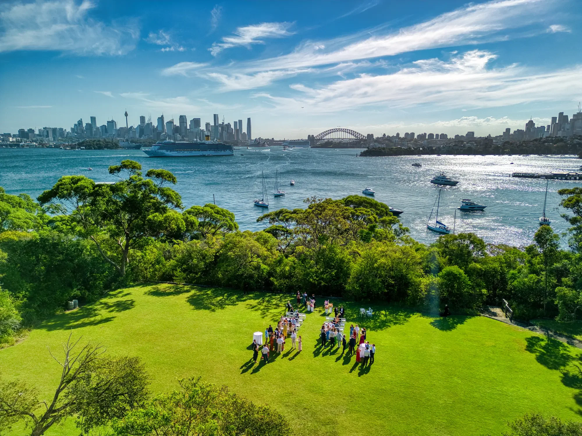 wedding-drone-sydney-harbour-yacht-cbd-skyline-sunset.webp