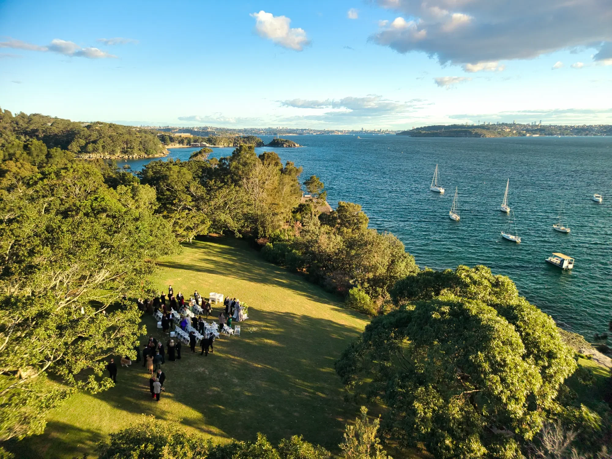 wedding-drone-little-manly-headland-lawn-ceremony-golden-hour-aerial.webp
