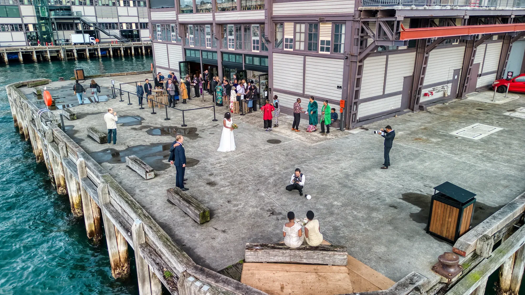 wedding-drone-walsh-bay-wharf-guests-aerial.webp