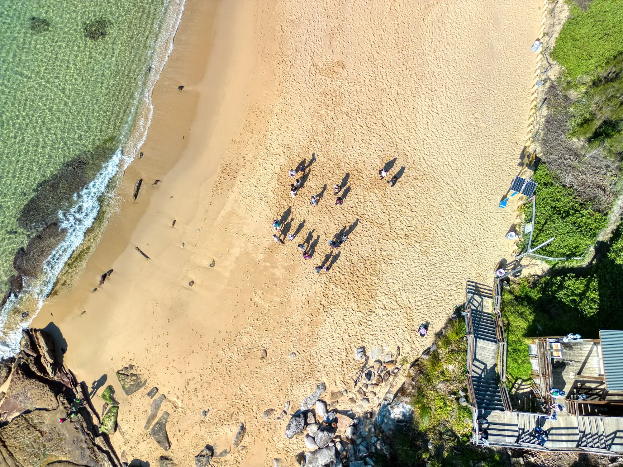 wedding-proposal-drone-little-beach-topdown-aerial.webp
