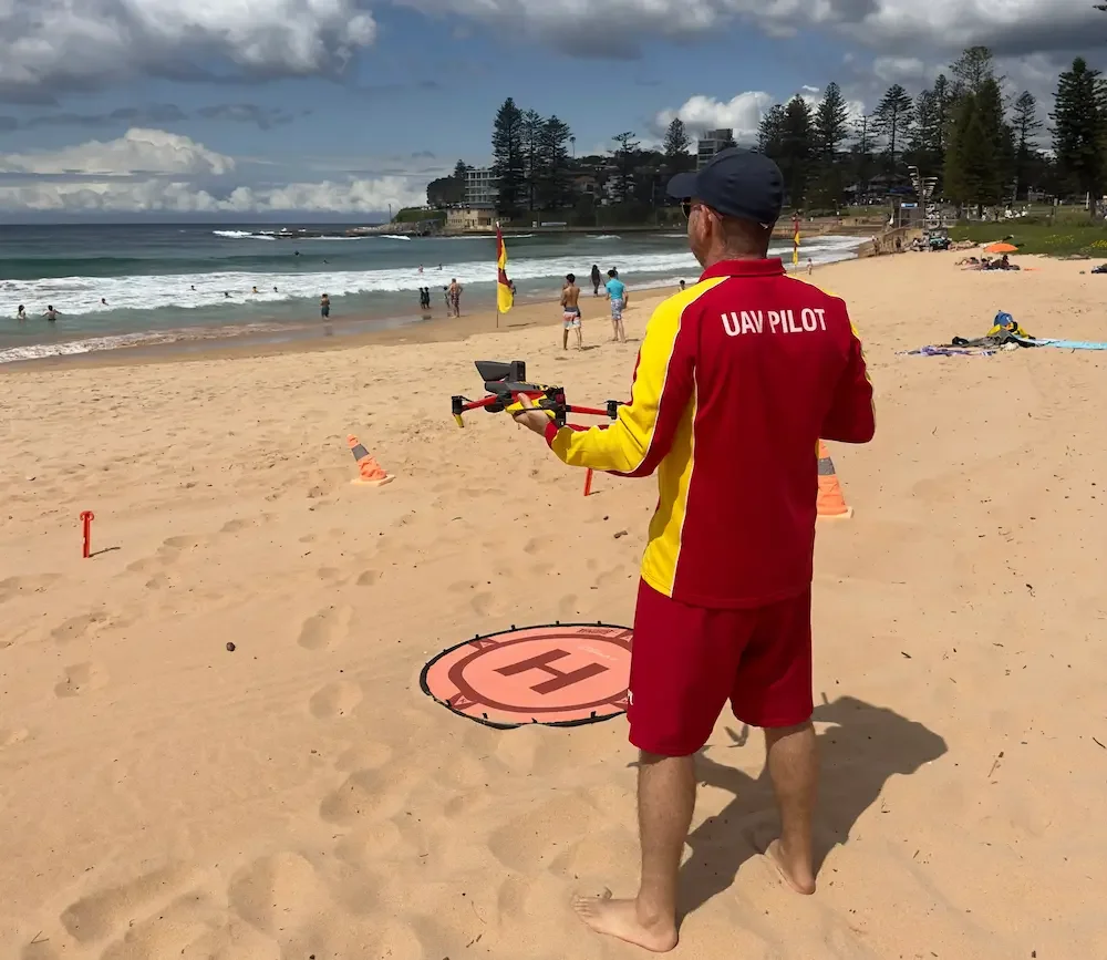 CASA-licensed UAV pilot conducting shark surveillance operations for Surf Life Saving NSW on Dee Why Beach — Batuti Photos