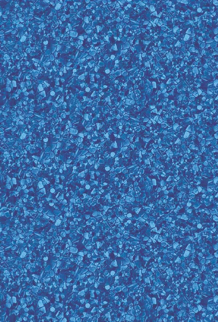 Close-up of a textured blue surface with small, irregular shapes