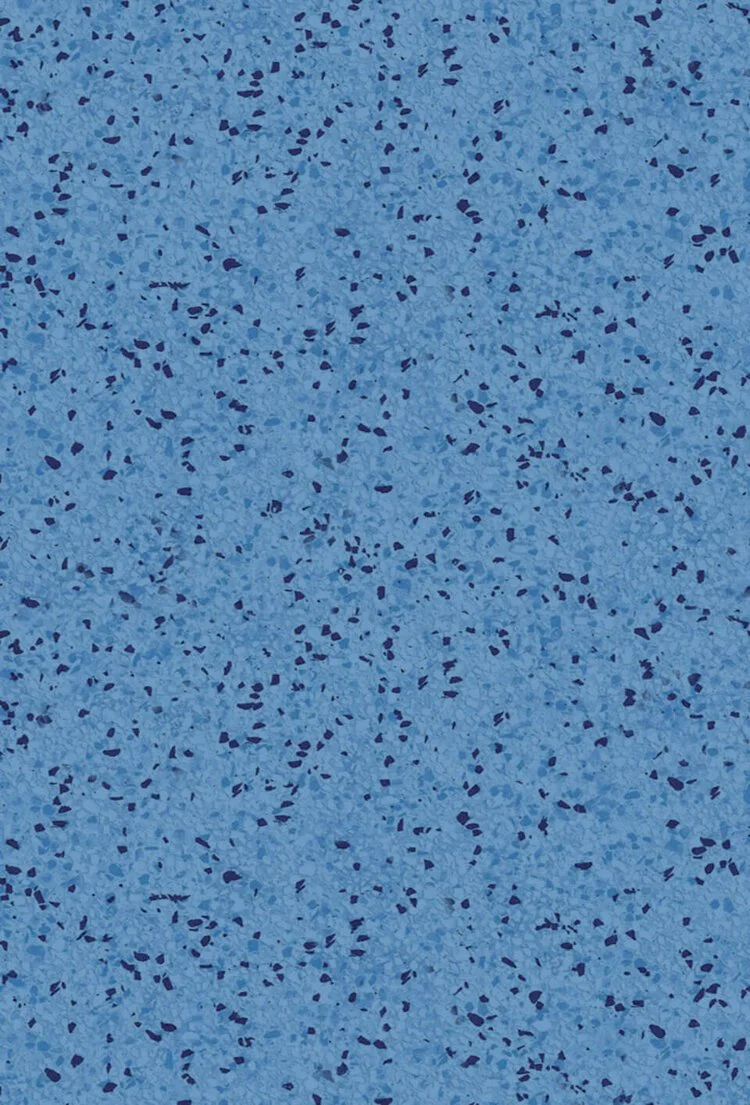 Close-up of a speckled blue rubber exercise or sports flooring surface.