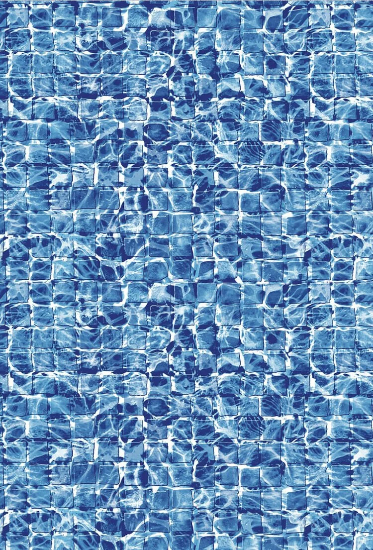 Close-up of a swimming pool with blue mosaic tiles and water reflections.