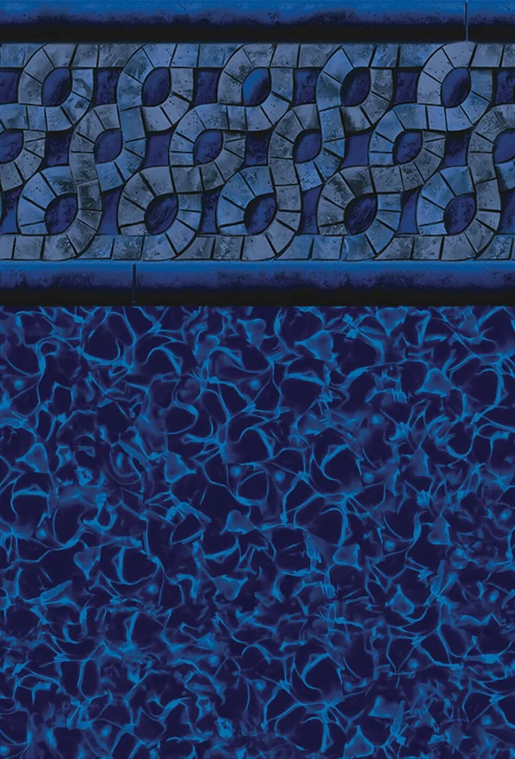 Close-up of a mosaic tiled wall with a blue-and-purple color scheme, featuring a geometric pattern above a textured surface that resembles cracked or shattered material illuminated with blue light.