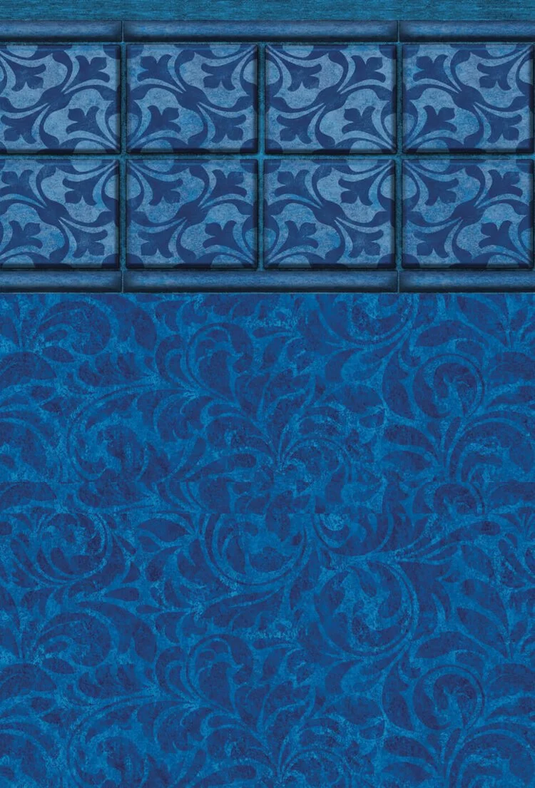 Blue decorative wall with patterned tile blocks and a floral textured surface below.