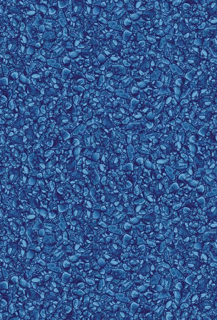 Close-up view of a textured surface with small and medium pebbles embedded in a dark blue resin or concrete material.
