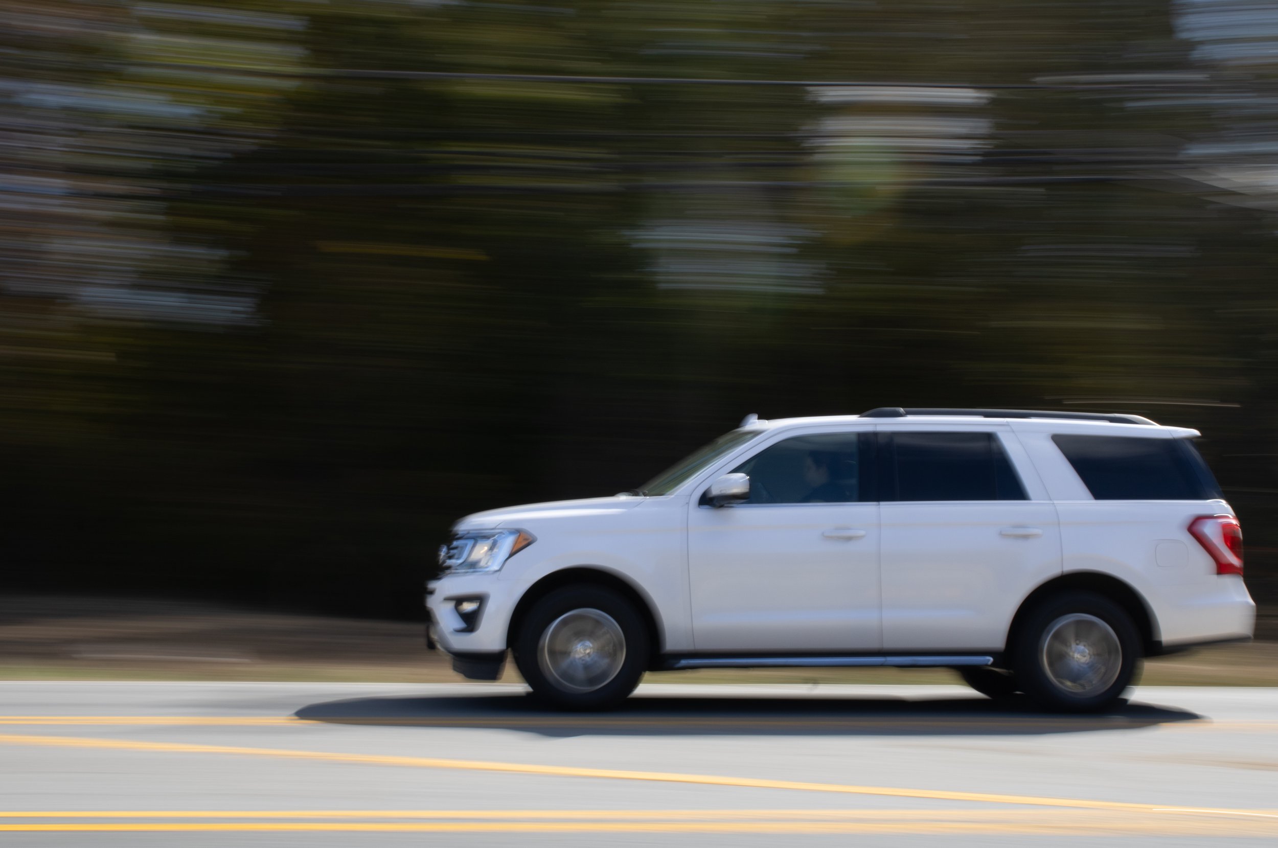 Panning shot of white SUV