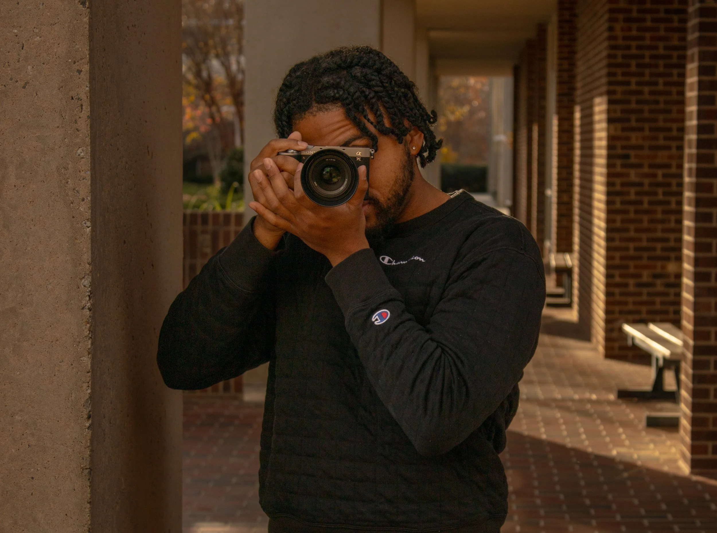 Portrait of a man taking a picture outdoors